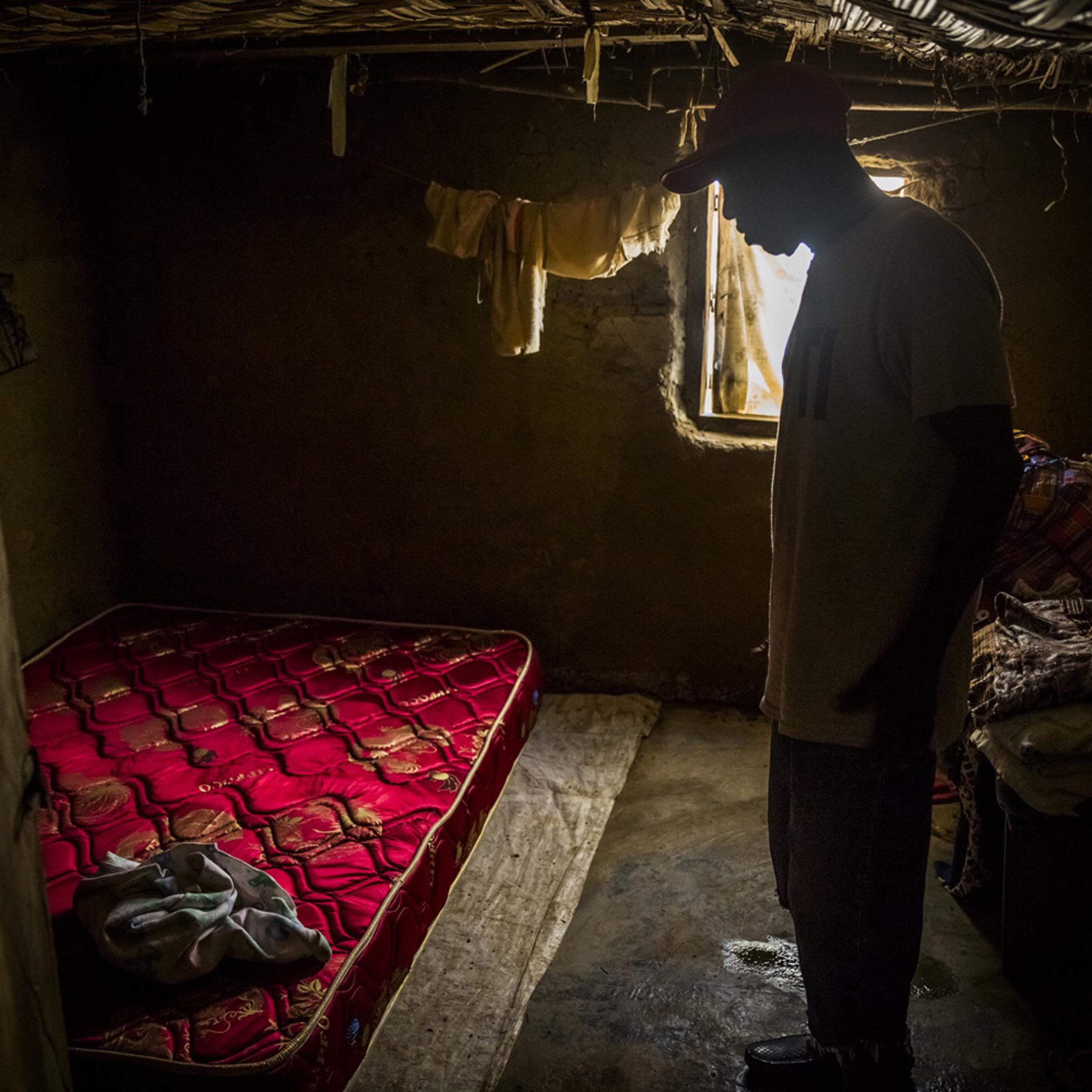 John Yarkpawolo looks over the body of four-day-old Diana Dormeyan, his granddaughter, whose mother died while giving birth to her, at their family home in Gbarnga, Liberia, Oct. 8, 2014.