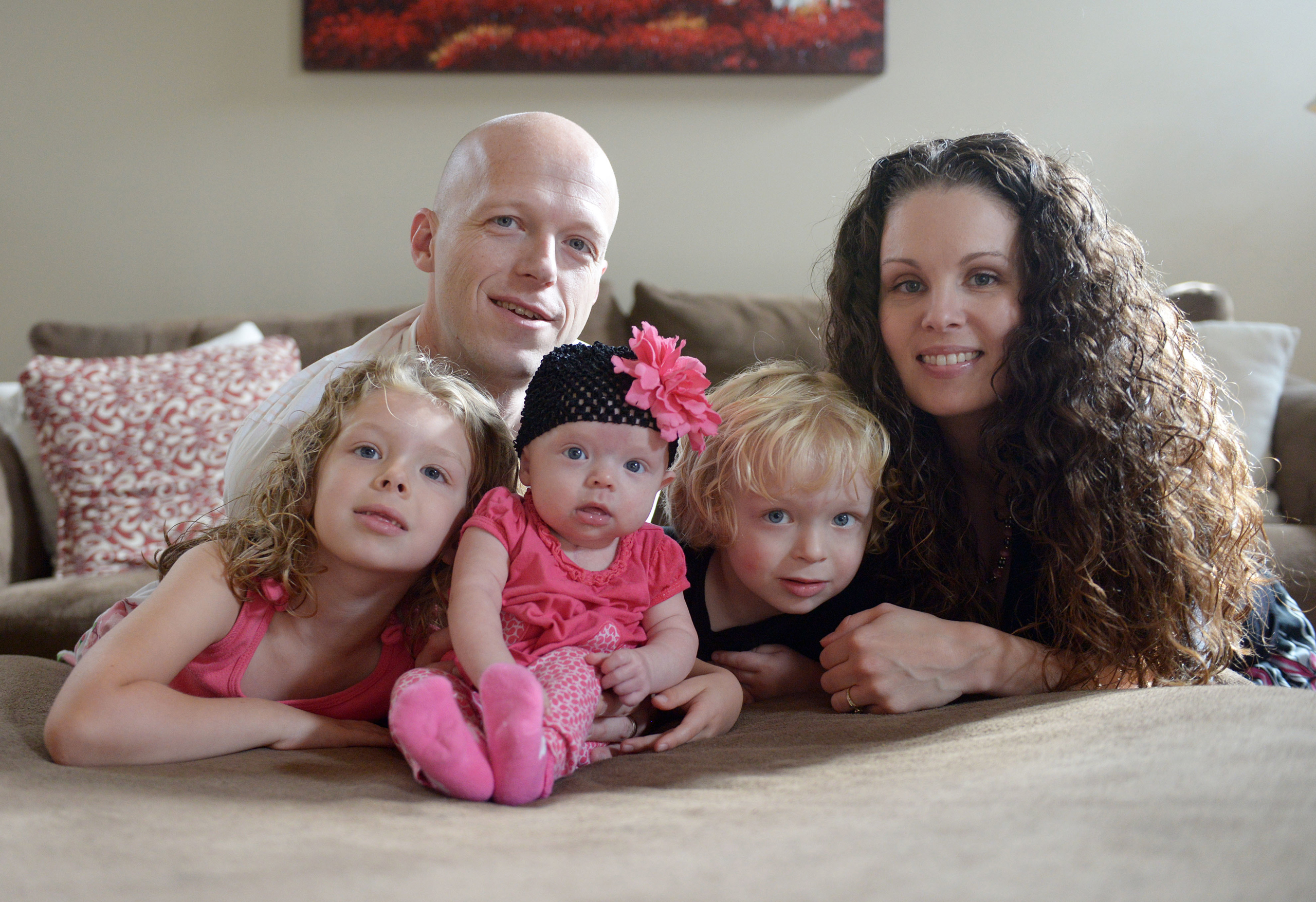 In this Sept. 1, 2014, photo, Willow Short, 4-month-old, center, along with her parents Megan and Mark and sister Liana, 6, and brother Mark, 3, poses for a photo in Sinking Spring, Pa. Willow Short had a heart transplant at 6-days-old. The couple featur