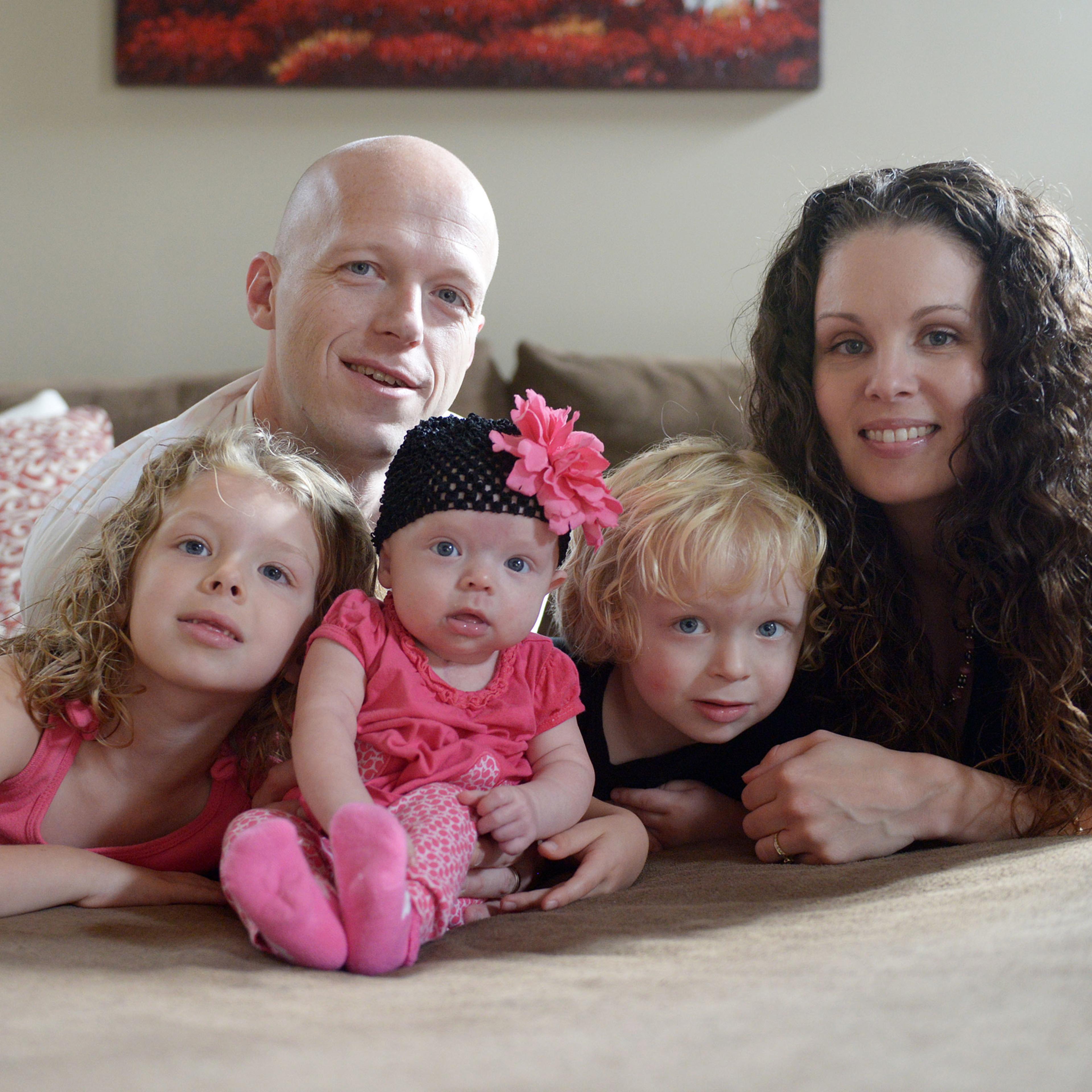 In this Sept. 1, 2014, photo, Willow Short, 4-month-old, center, along with her parents Megan and Mark and sister Liana, 6, and brother Mark, 3, poses for a photo in Sinking Spring, Pa. Willow Short had a heart transplant at 6-days-old. The couple featur