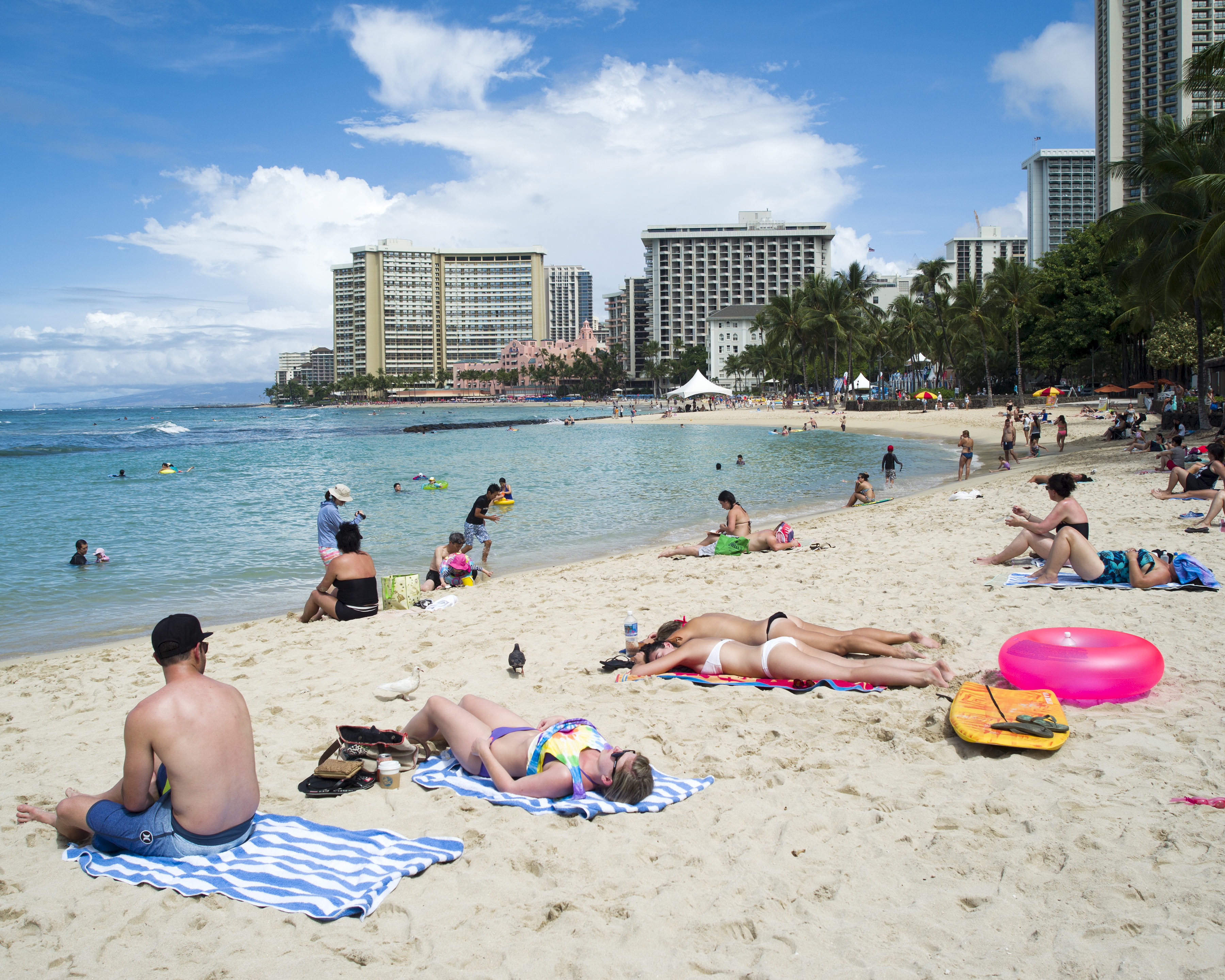 People are pictured at Waikiki Beach in Honolulu, Hawaii