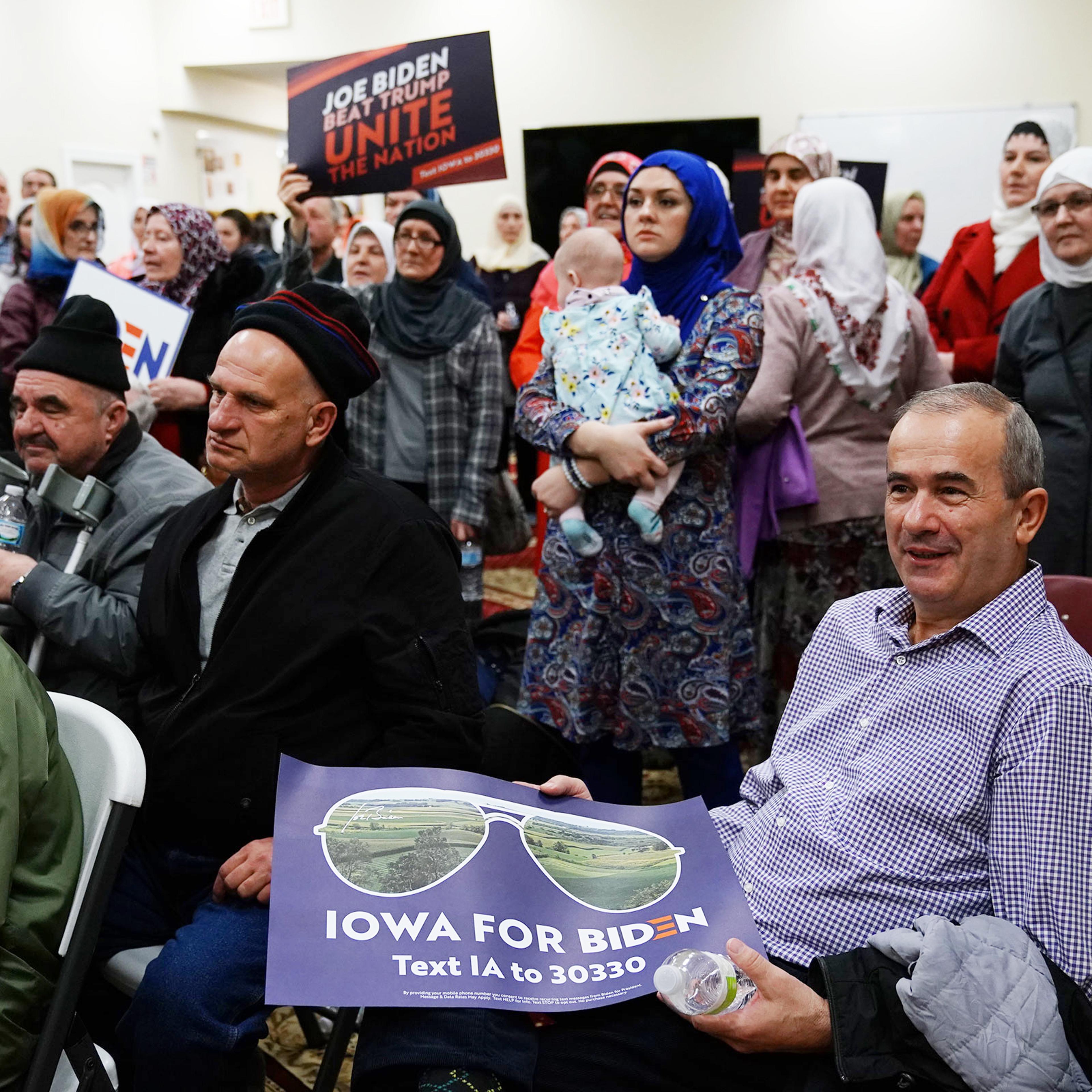Participants hold campaign signs for Vice President Joe Biden during the first-in-the-nation Iowa caucus at the Islamic and Education Center Ezan mosque in Des Moines, Iowa on Feb. 3, 2020.