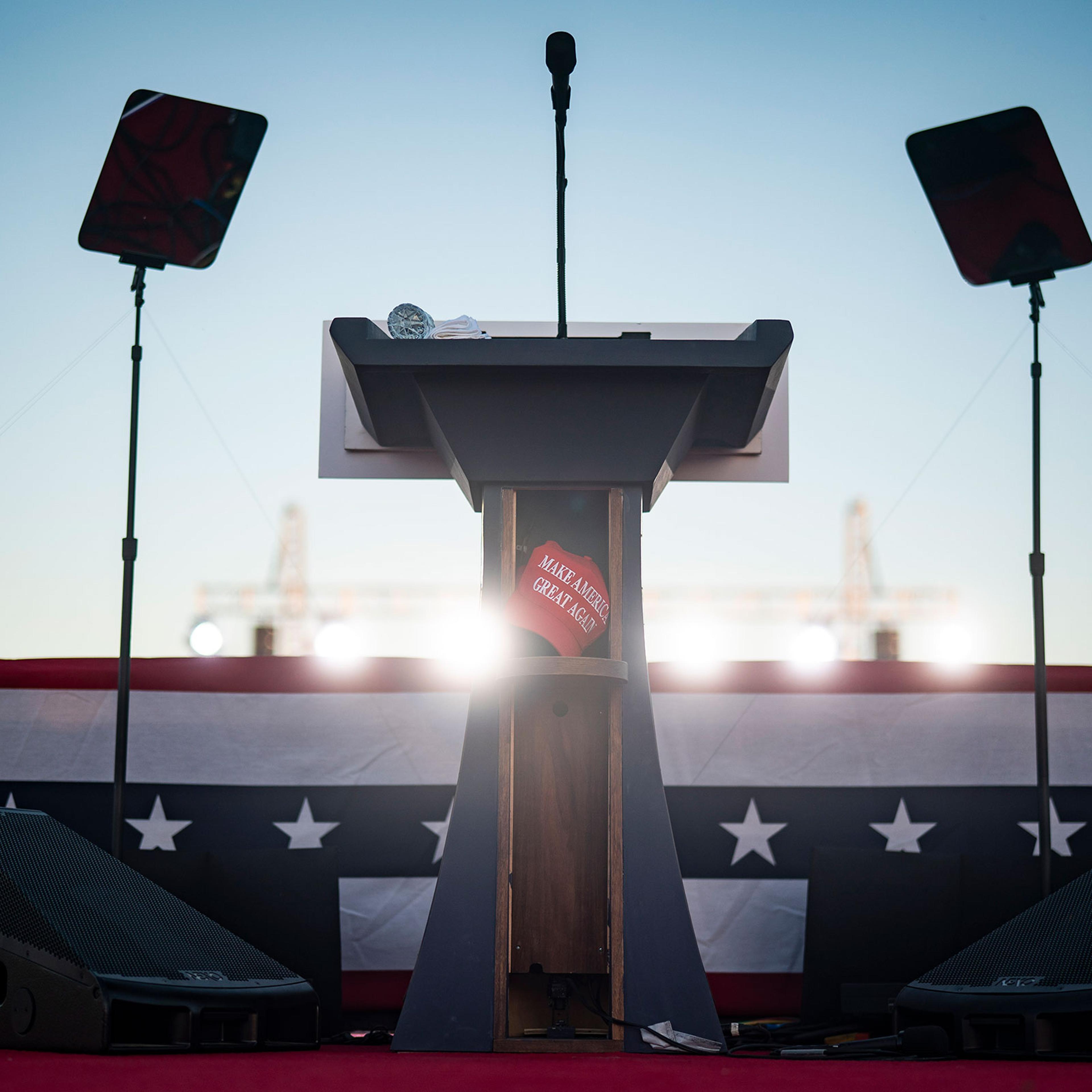 A Make America Great Again hat is seen left behind on the podium by former President Donald Trump after he spoke at a campaign rally at the Waco Regional Airport on March 25, 2023.