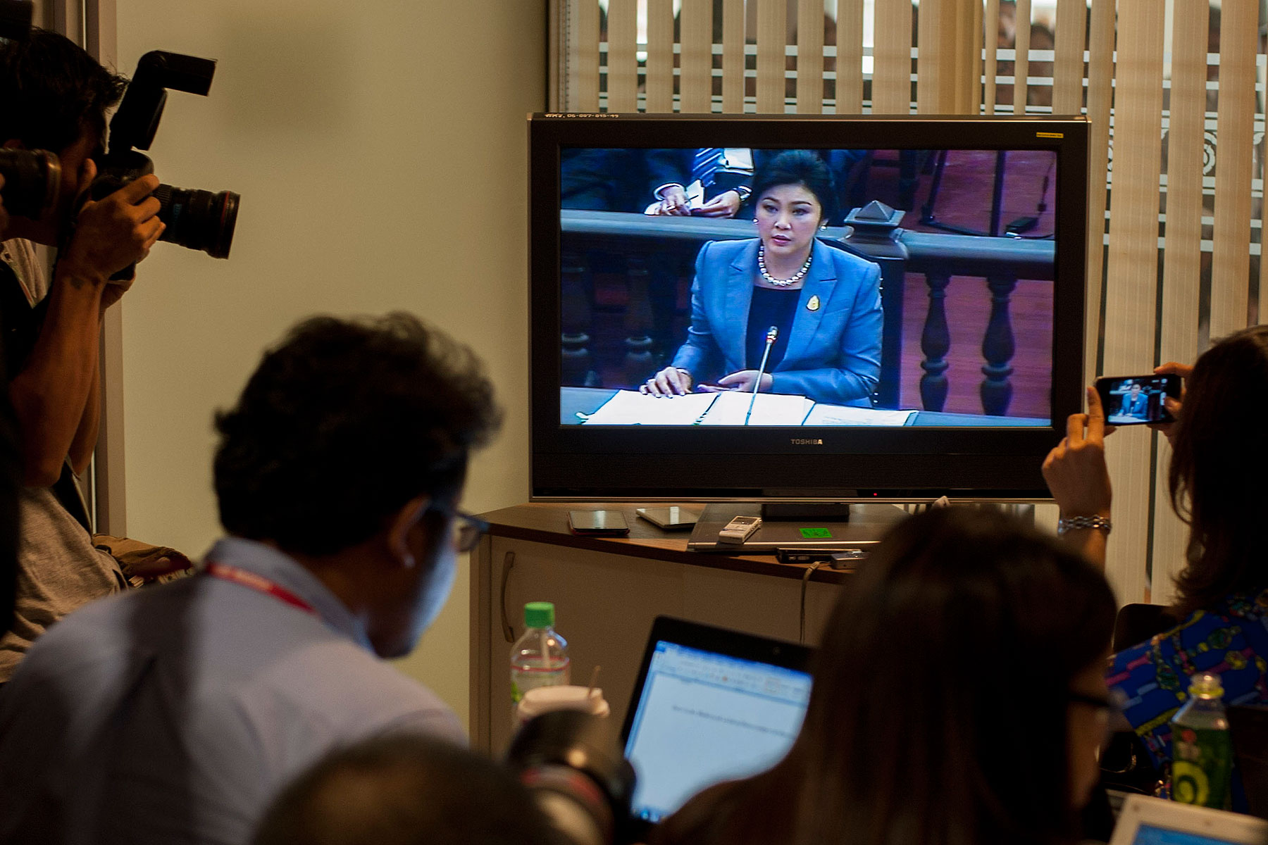 Thai Prime Minister Yingluck Shinawatra is seen on a TV during her statement at the Constitutional Court on May 6, 2014, in Bangkok