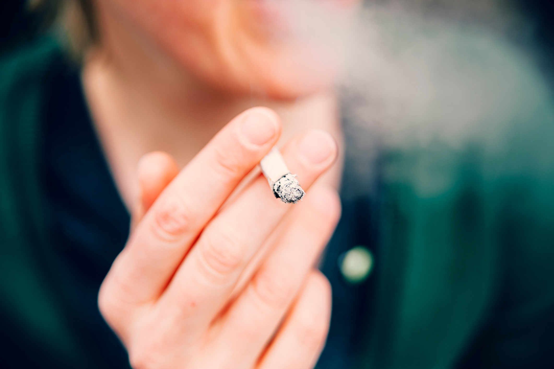 Cropped hand holding cigarette