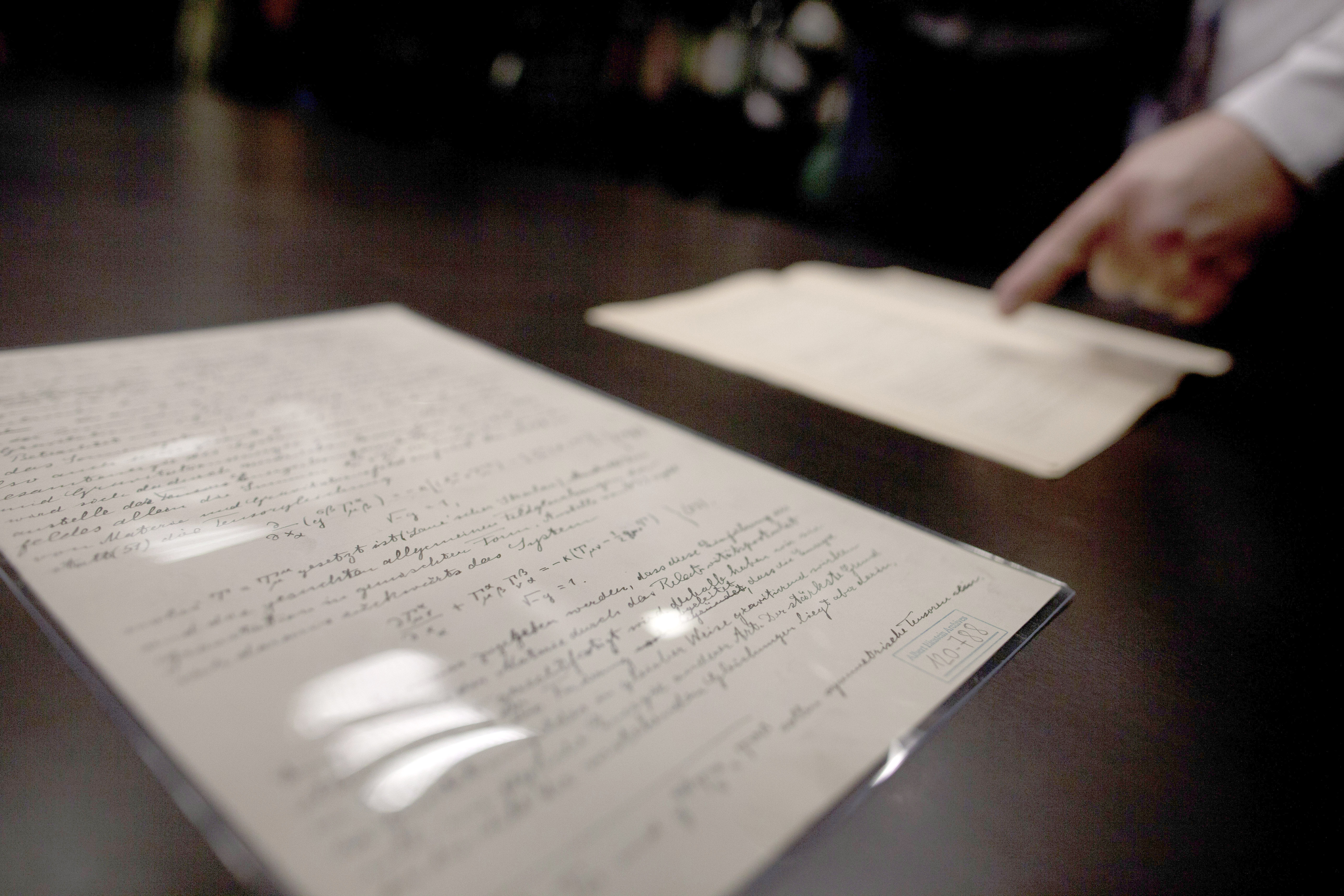 JERUSALEM, ISRAEL - FEBRUARY 11:  Head of Einstein Archives Dr. Roni Gross of the Hebrew University presents the original 100 years old documents of Einstein's prediction of the existence of gravitational waves at the Albert Einstein Archives of the Hebr