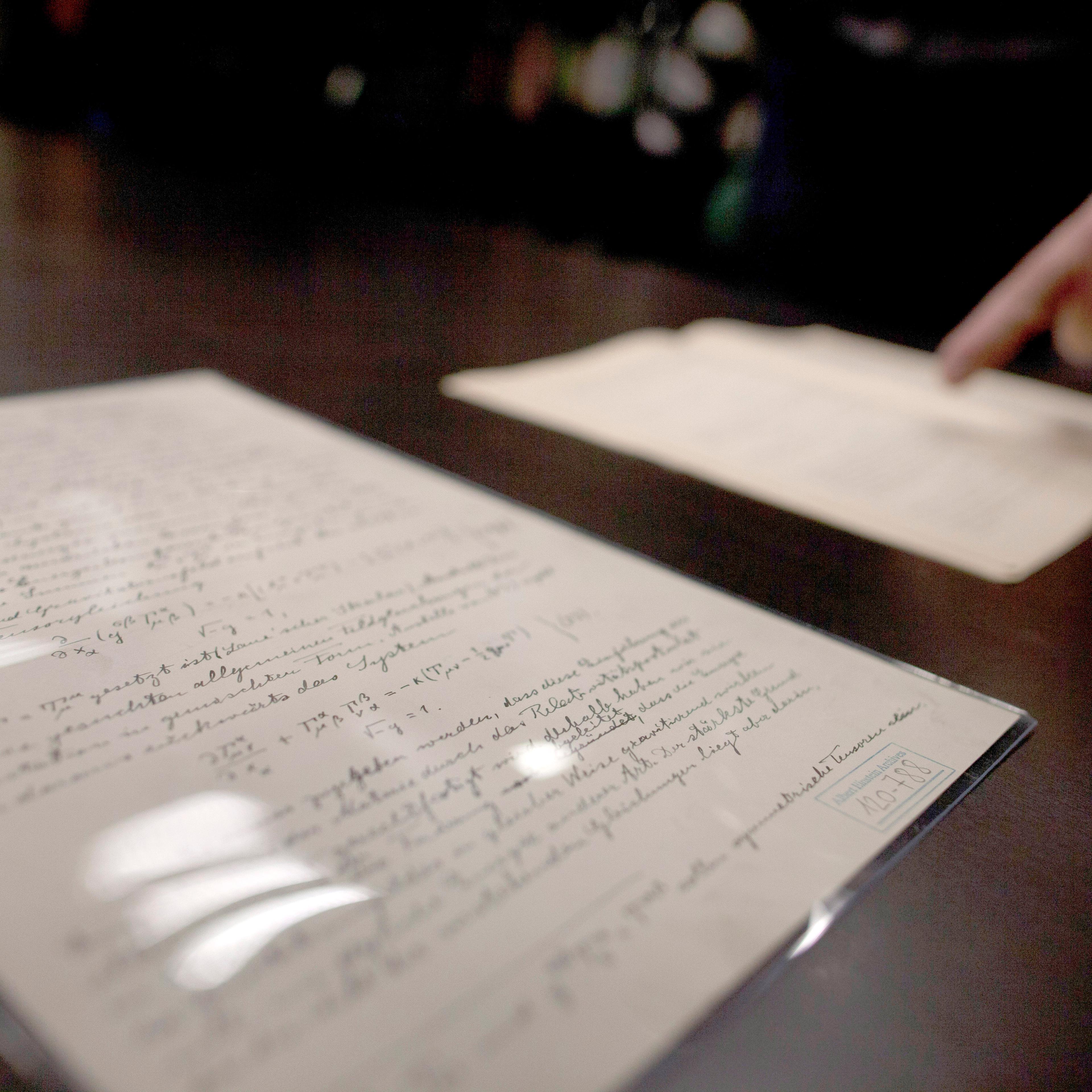 JERUSALEM, ISRAEL - FEBRUARY 11: Head of Einstein Archives Dr. Roni Gross of the Hebrew University presents the original 100 years old documents of Einstein's prediction of the existence of gravitational waves at the Albert Einstein Archives of the Hebr