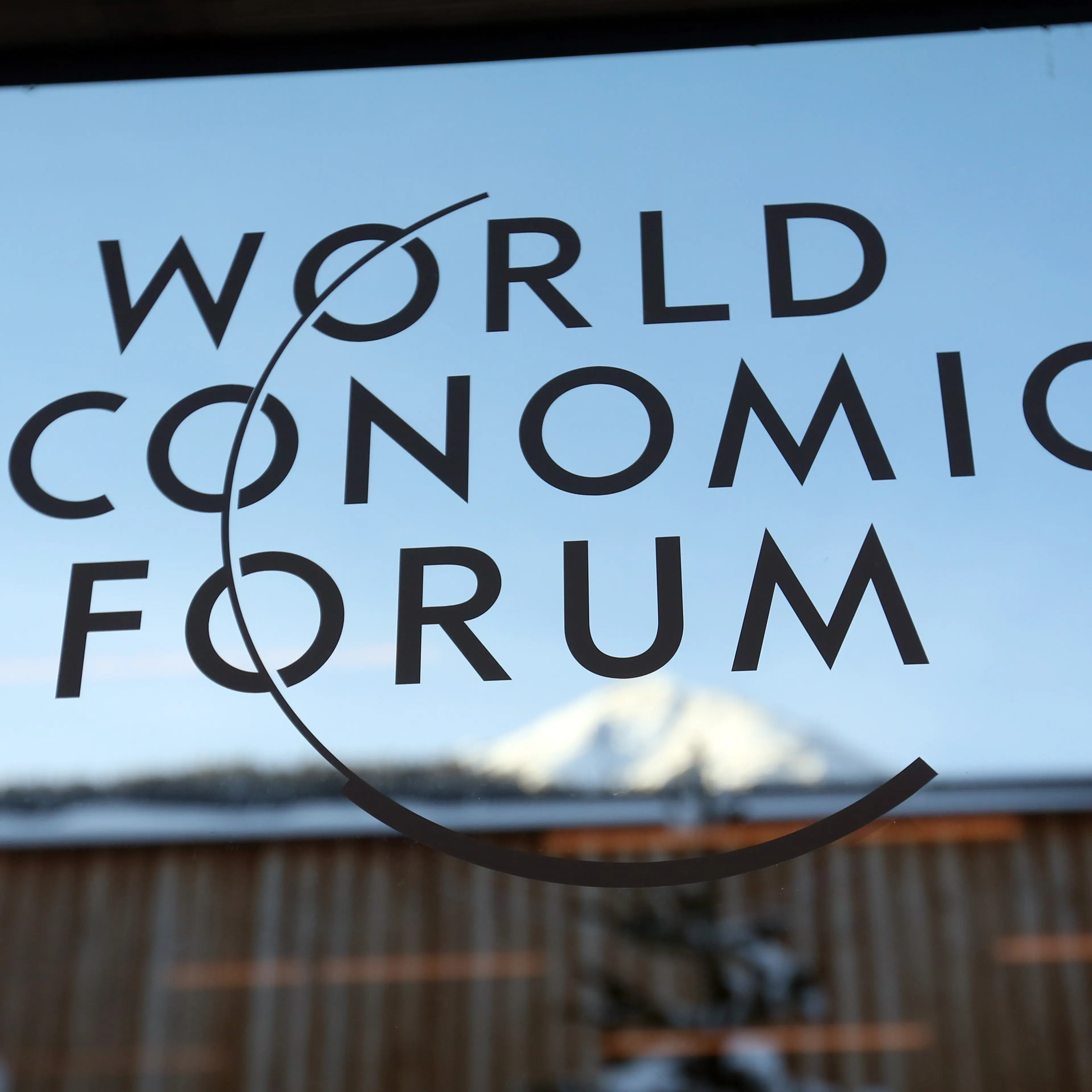 A logo sits on a glass panel inside the venue of the World Economic Forum (WEF) in Davos, Switzerland on Jan. 19, 2015.