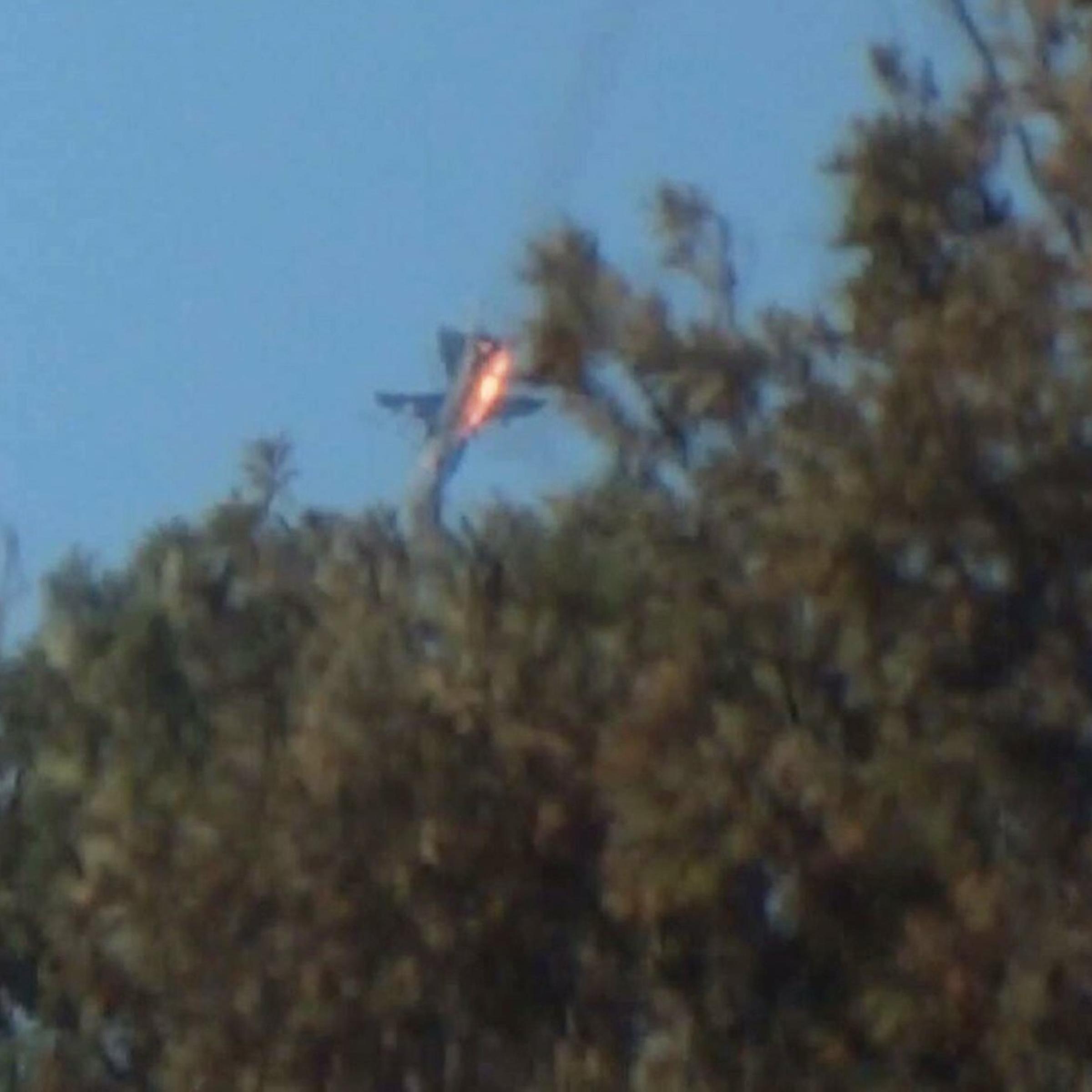 A war plane crashes in flames in a mountainous area in northern Syria after it was shot down by Turkish fighter jets near the Turkish-Syrian border
