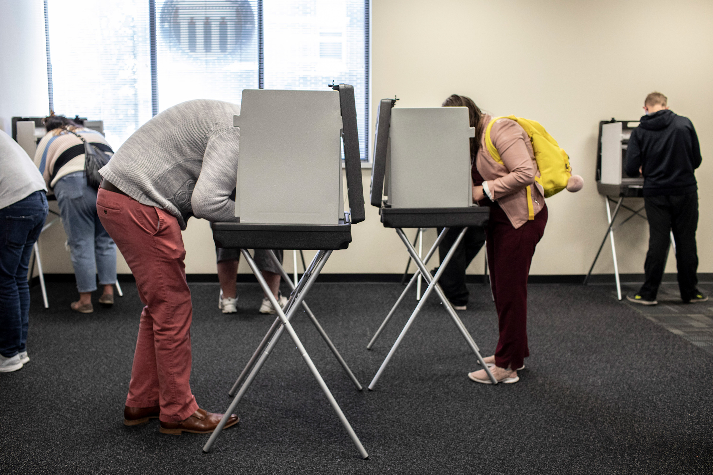 People cast ballots on the first day of early voting in Des Moines, Iowa, Oct. 5.