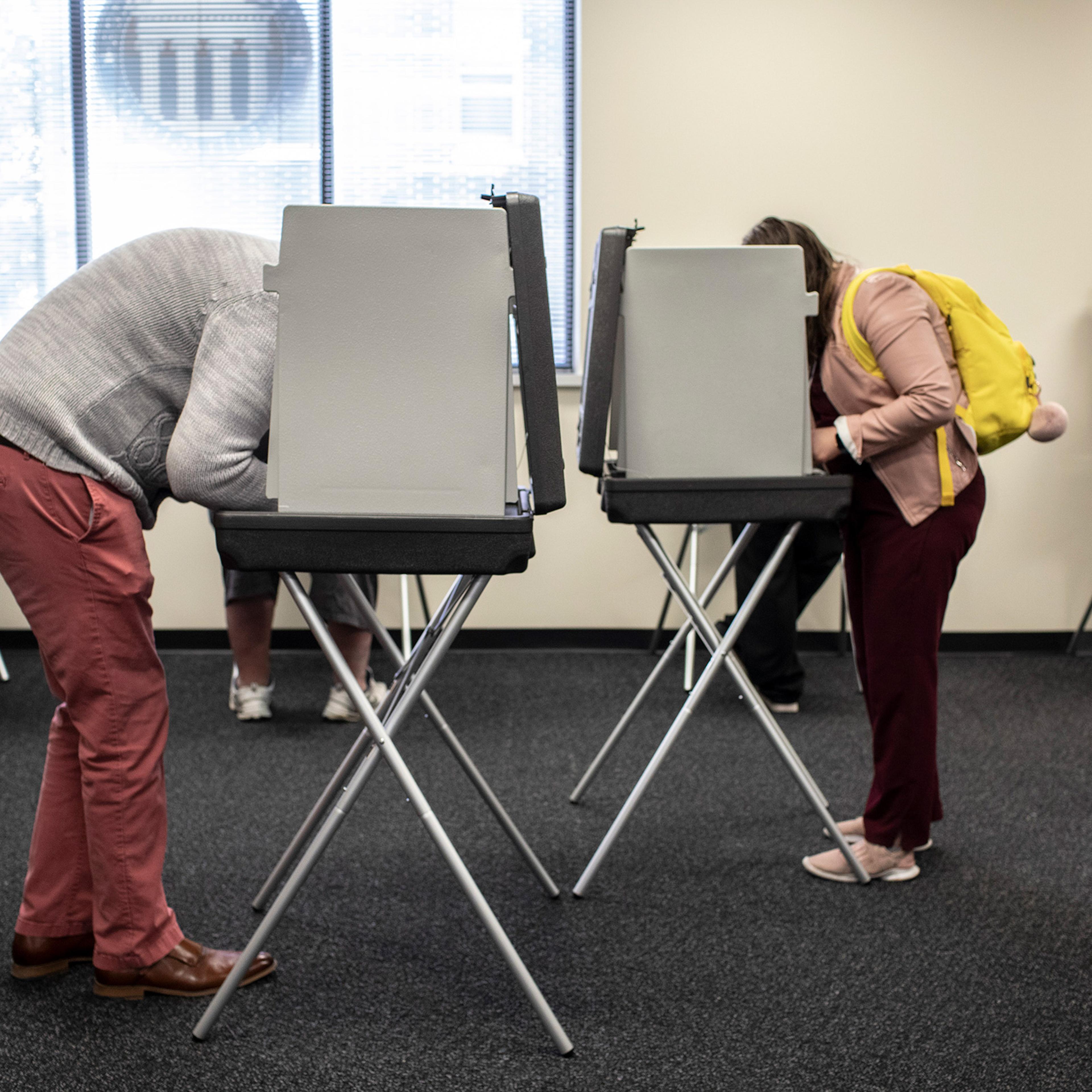 People cast ballots on the first day of early voting in Des Moines, Iowa, Oct. 5.