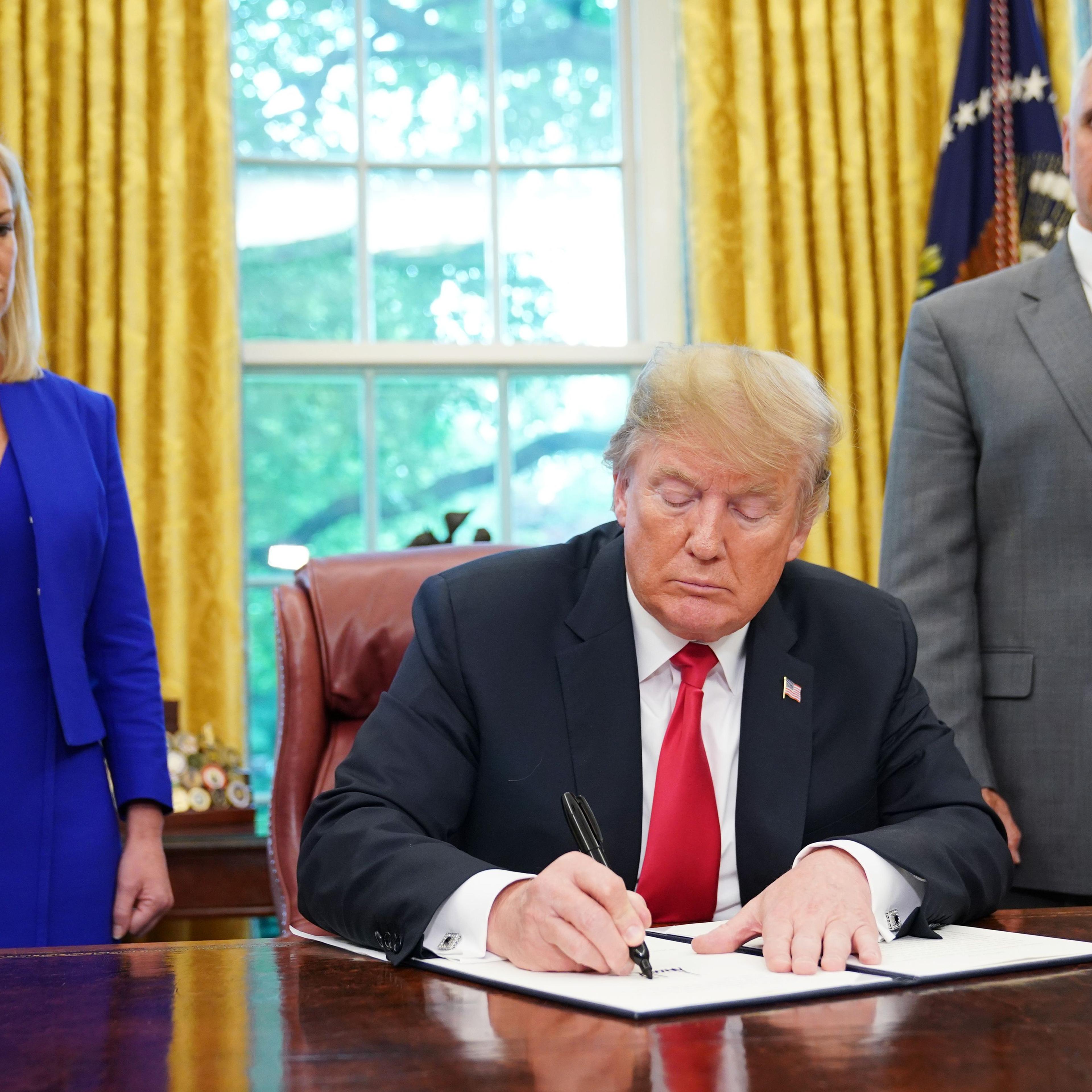 US-POLITICS-IMMIGRATION-TRUMP-SIGN-MIGRANTS