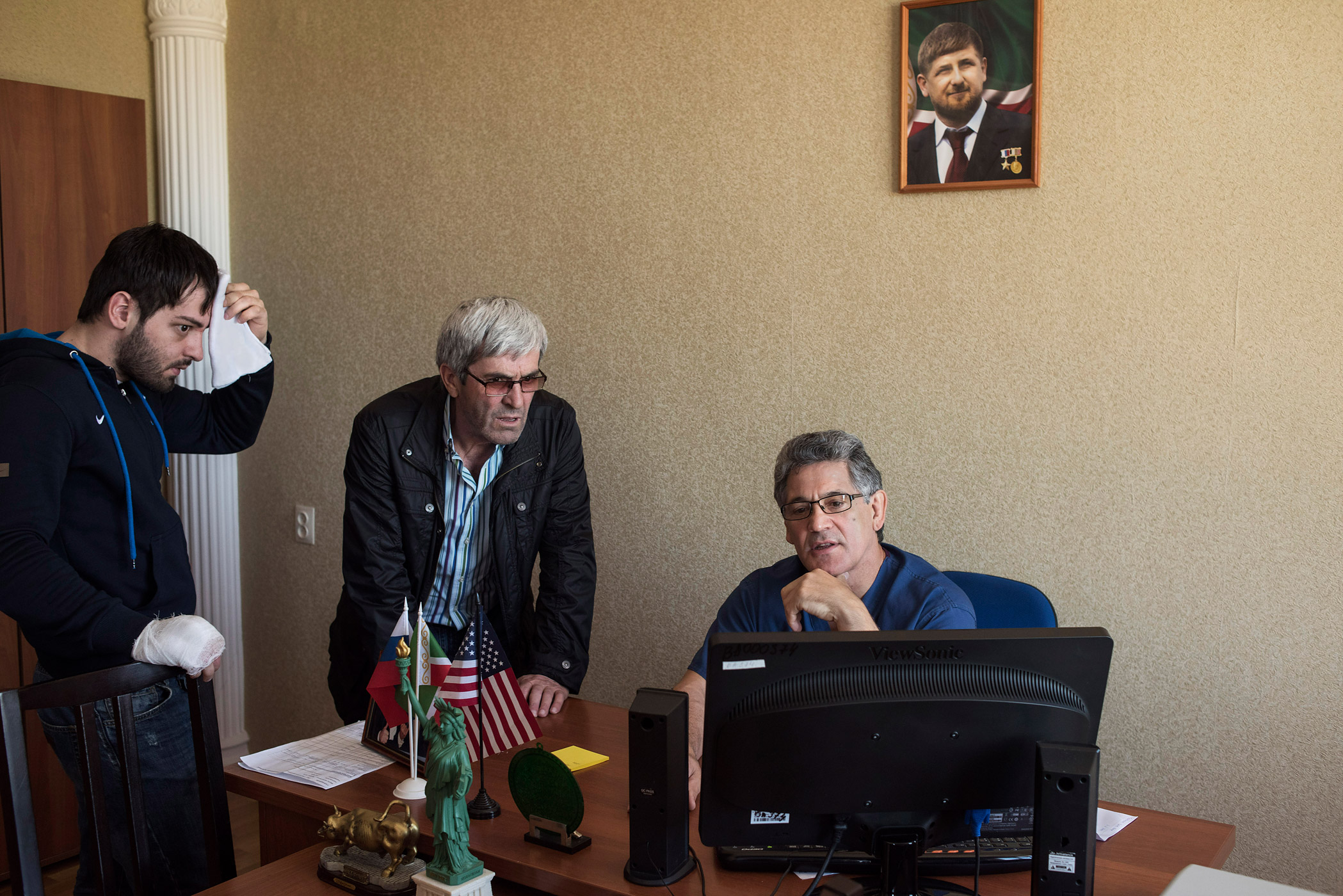 Dr. Khassan Baiev talks  to a patient and his father at the children's hospital in Grozny, the capital of Chechnya, on April 17, 2015.