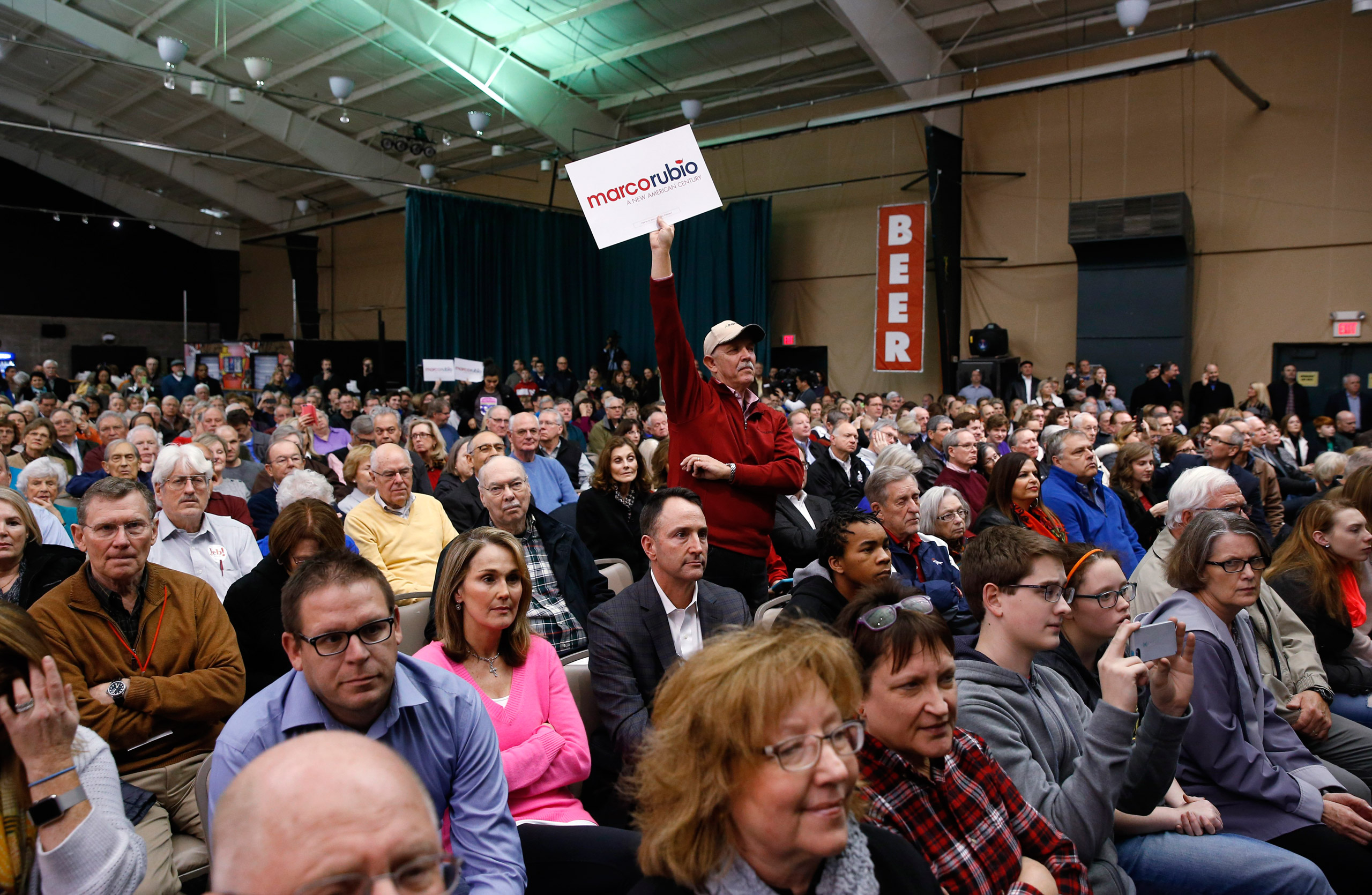 A supporter for Republican presidential candidate Sen. Marco Rubio, R-Fla., holds a sign up at a caucus site, Monday, Feb. 1, 2016 in Clive, Iowa. (AP Photo/Paul Sancya)