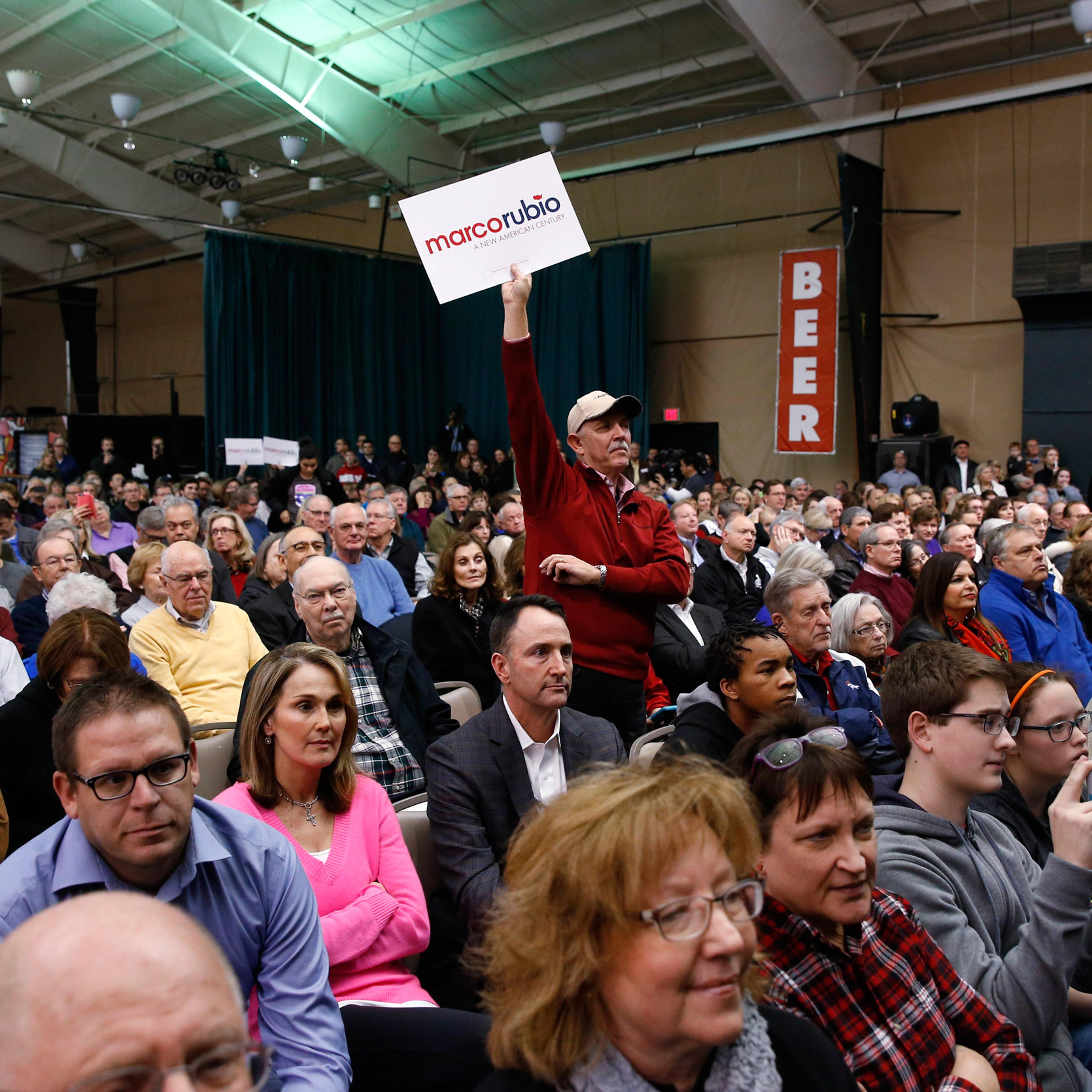 A supporter for Republican presidential candidate Sen. Marco Rubio, R-Fla., holds a sign up at a caucus site, Monday, Feb. 1, 2016 in Clive, Iowa. (AP Photo/Paul Sancya)