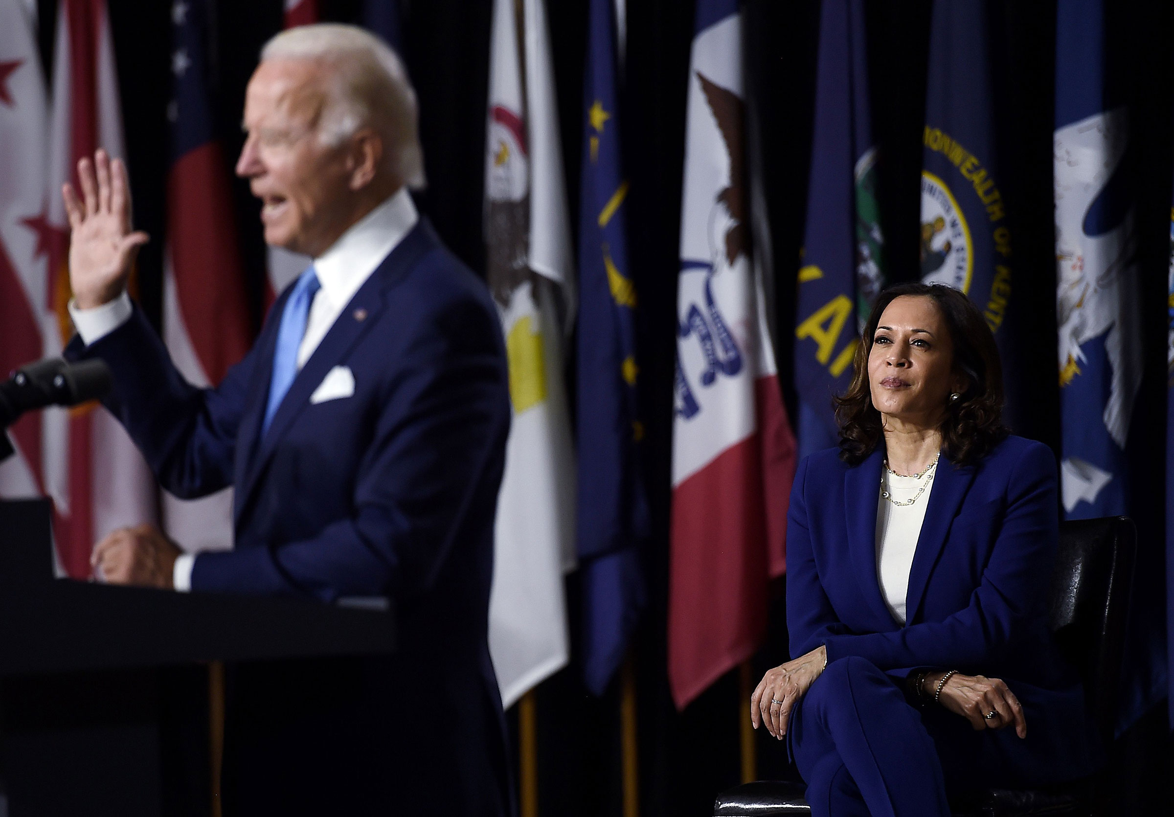 Democratic vice presidential running mate, Sen. Kamala Harris, listens to presidential nominee and former Vice President Joe Biden speak during their first press conference together