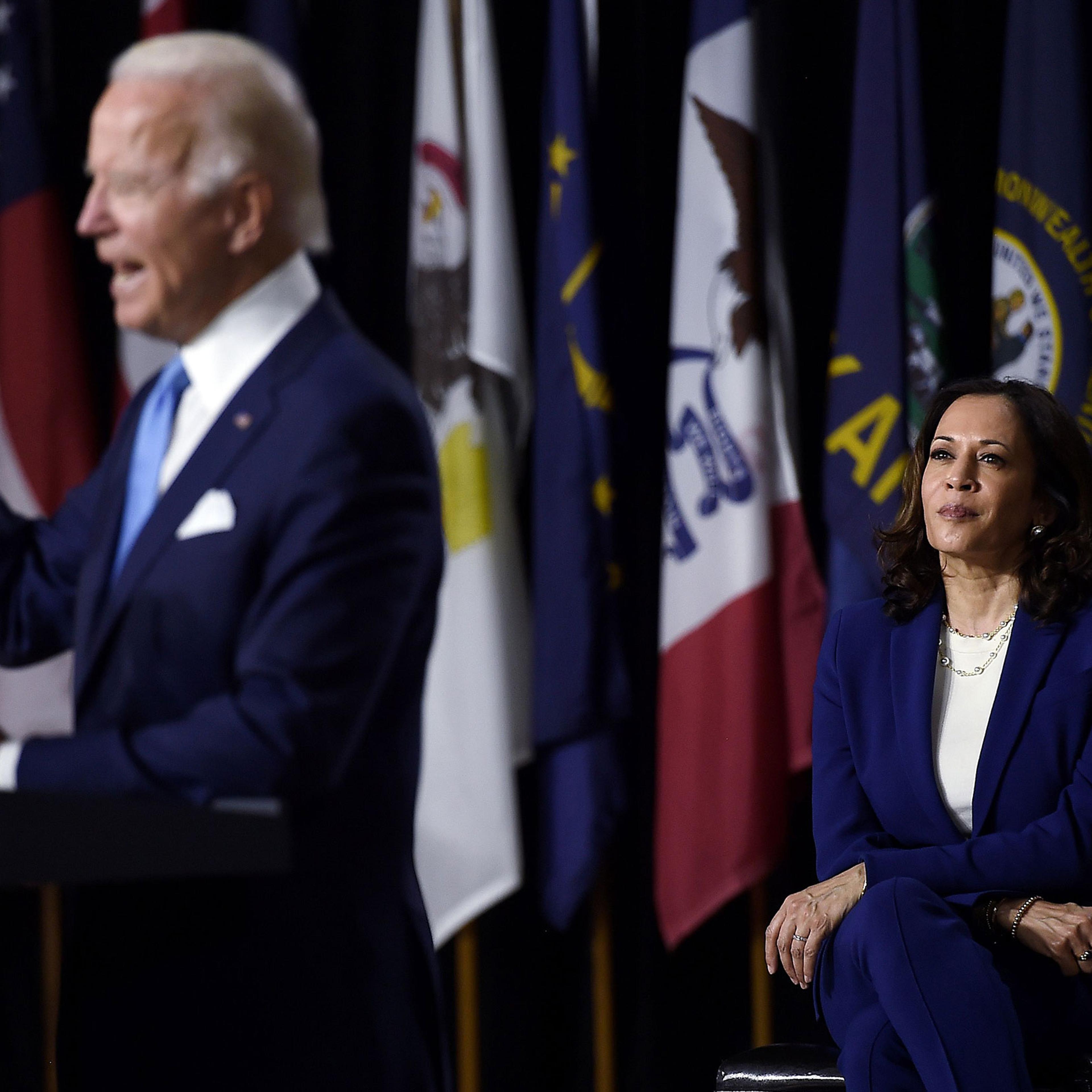 Democratic vice presidential running mate, Sen. Kamala Harris, listens to presidential nominee and former Vice President Joe Biden speak during their first press conference together