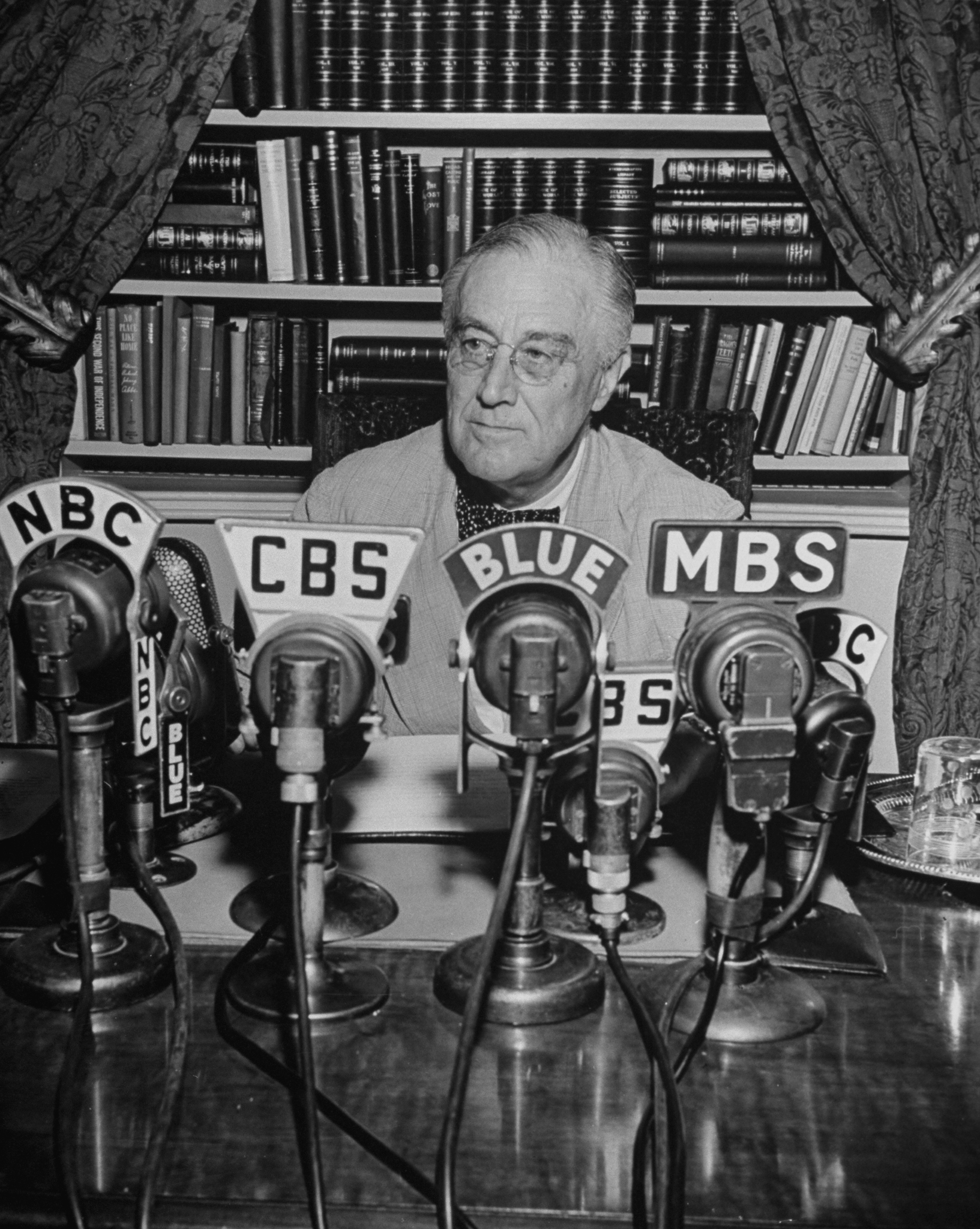 President Franklin D. Roosevelt, broadcasting a speech over the radio from the White House.