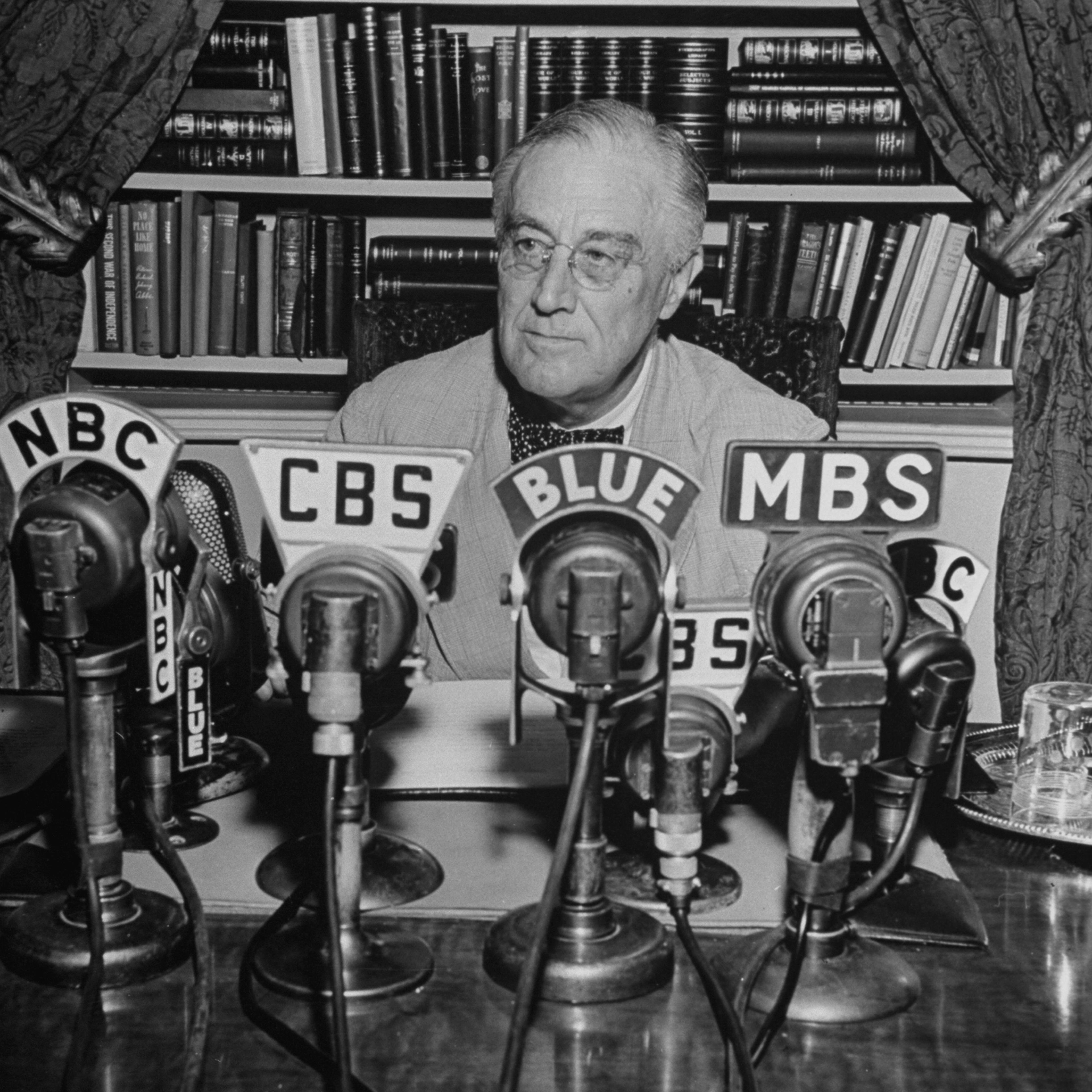 President Franklin D. Roosevelt, broadcasting a speech over the radio from the White House.