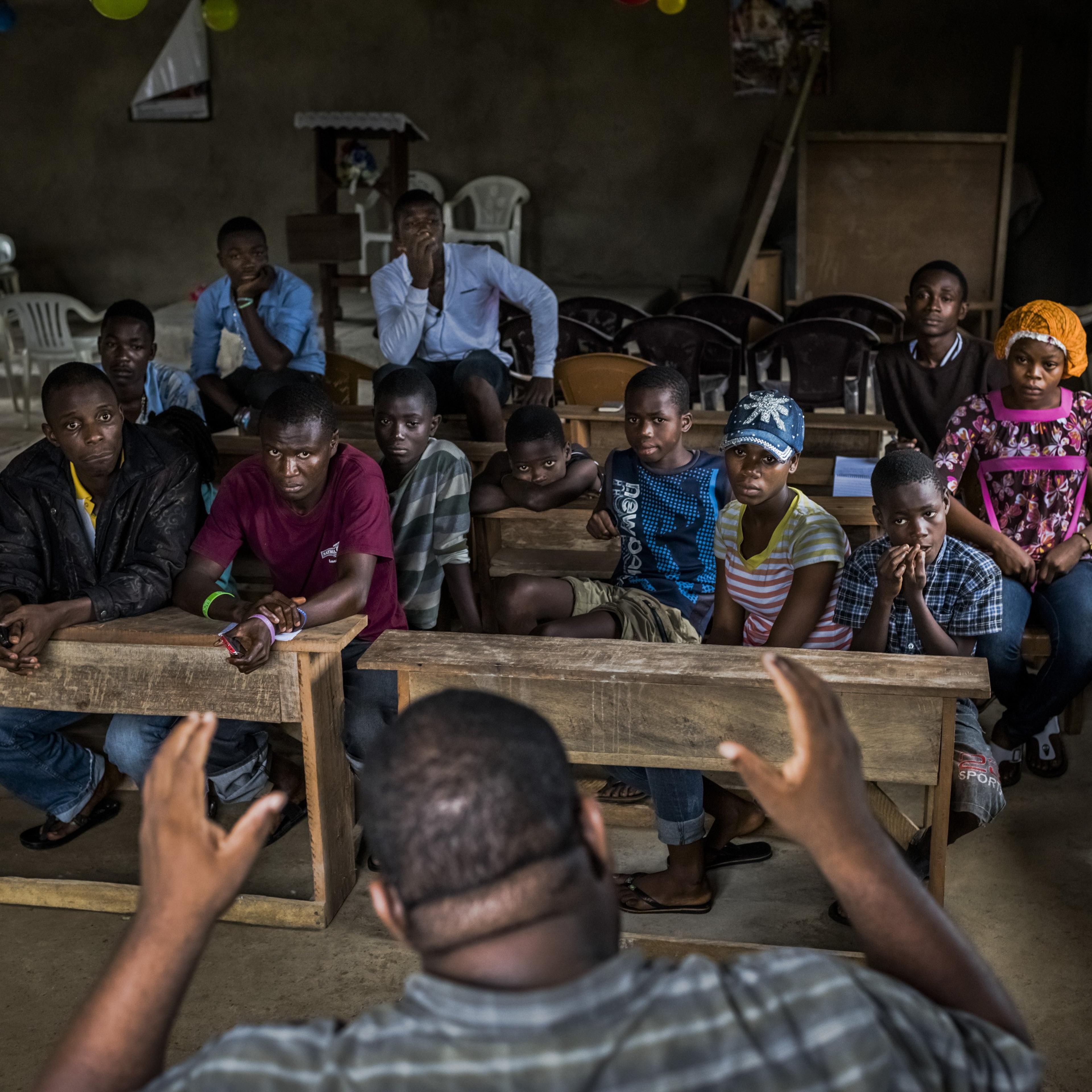 Dr. Mosoka Fallah, an epidemiologist and immunologist, speaks with residents during a neighborhood Ebola training session in Monrovia, Liberia.
