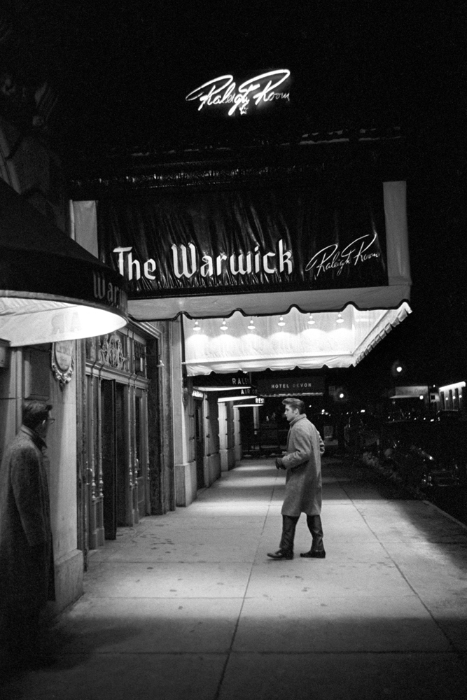 Each of the following captions include Wertheimer's first-person memories.  March 17, 1956. The Warwick, New York. A cold winter's day in March. Here Elvis is walking into his hotel alone. He and I were back there, in between the rehearsal and the evening performance [on the Dorsey Brothers "Stage Show"]. The little black spots on the sidewalk? That’s chewing gum that’s been ground into the pavement.