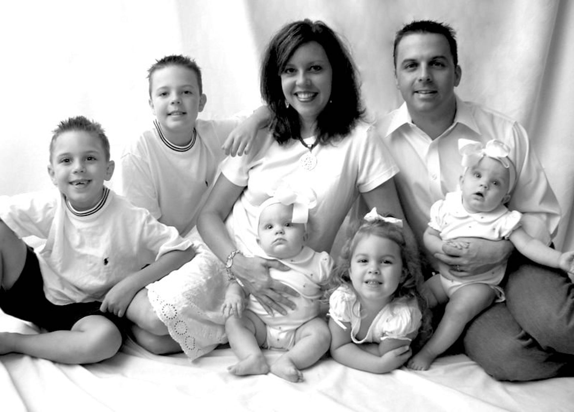 Ginger and Troy Gilbert with their sons (l-r) Greyson and Boston, and daughters Aspen, Bella and Annalise a week before Troy left for Iraq.