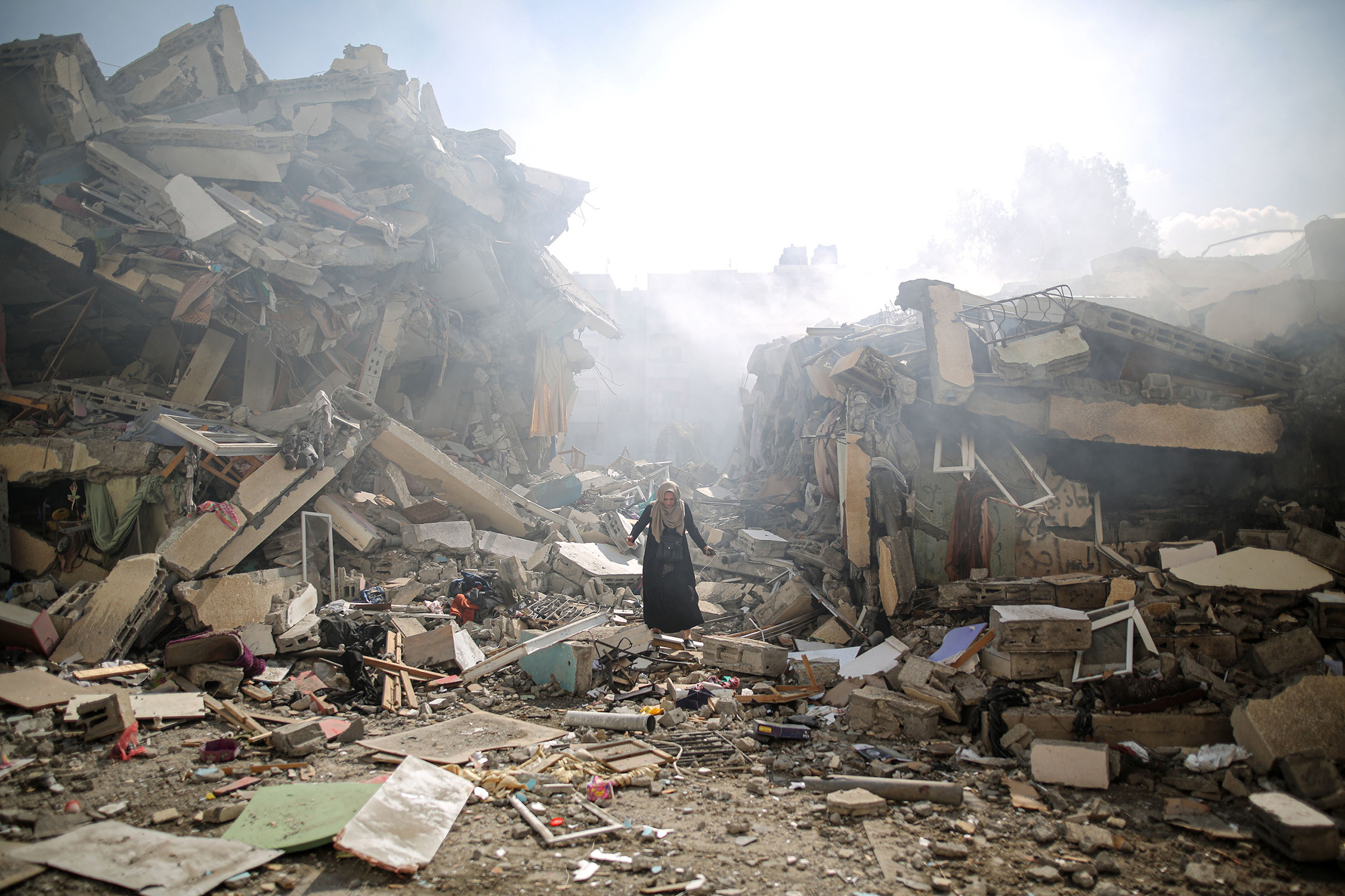 A resident walks the rubble of residential buildings after Israeli airstrikes at al-Zahra neighborhood in the Gaza Strip on Oct. 19, 2023.