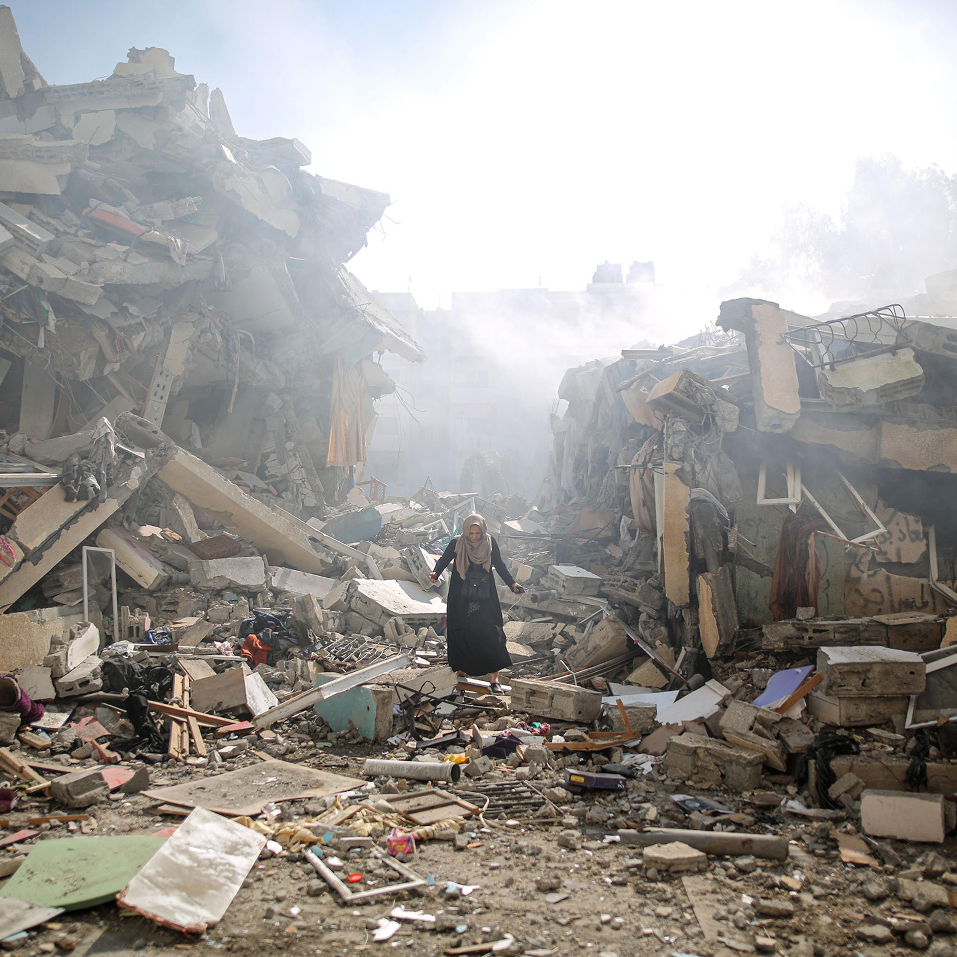 A resident walks the rubble of residential buildings after Israeli airstrikes at al-Zahra neighborhood in the Gaza Strip on Oct. 19, 2023.