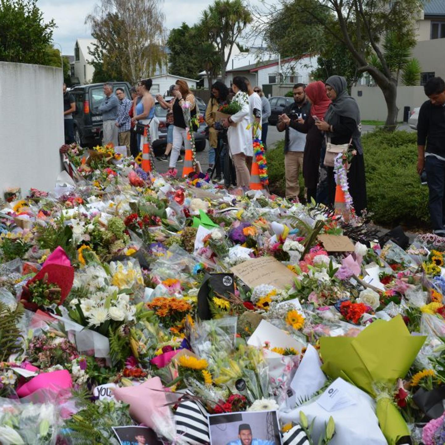 People place flowers at memorial sites as a tribute to victims of the Fridays terrorist attacks on two mosques that left at least 50 people killed in Christchurch
