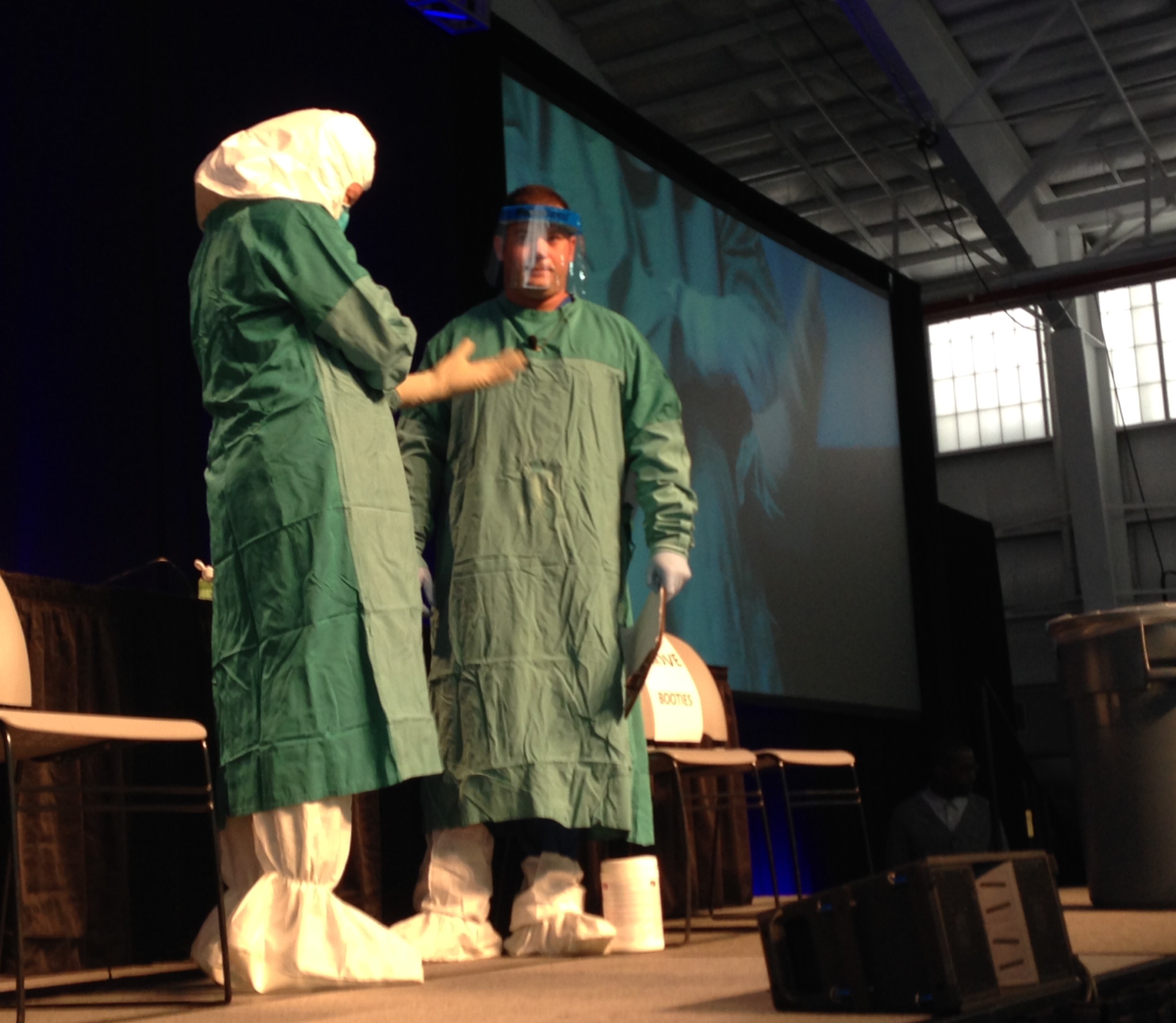 CDC and Mount Sinai health workers demonstrate how to put on and off Ebola personal protective equipment at an Ebola education session in New York City