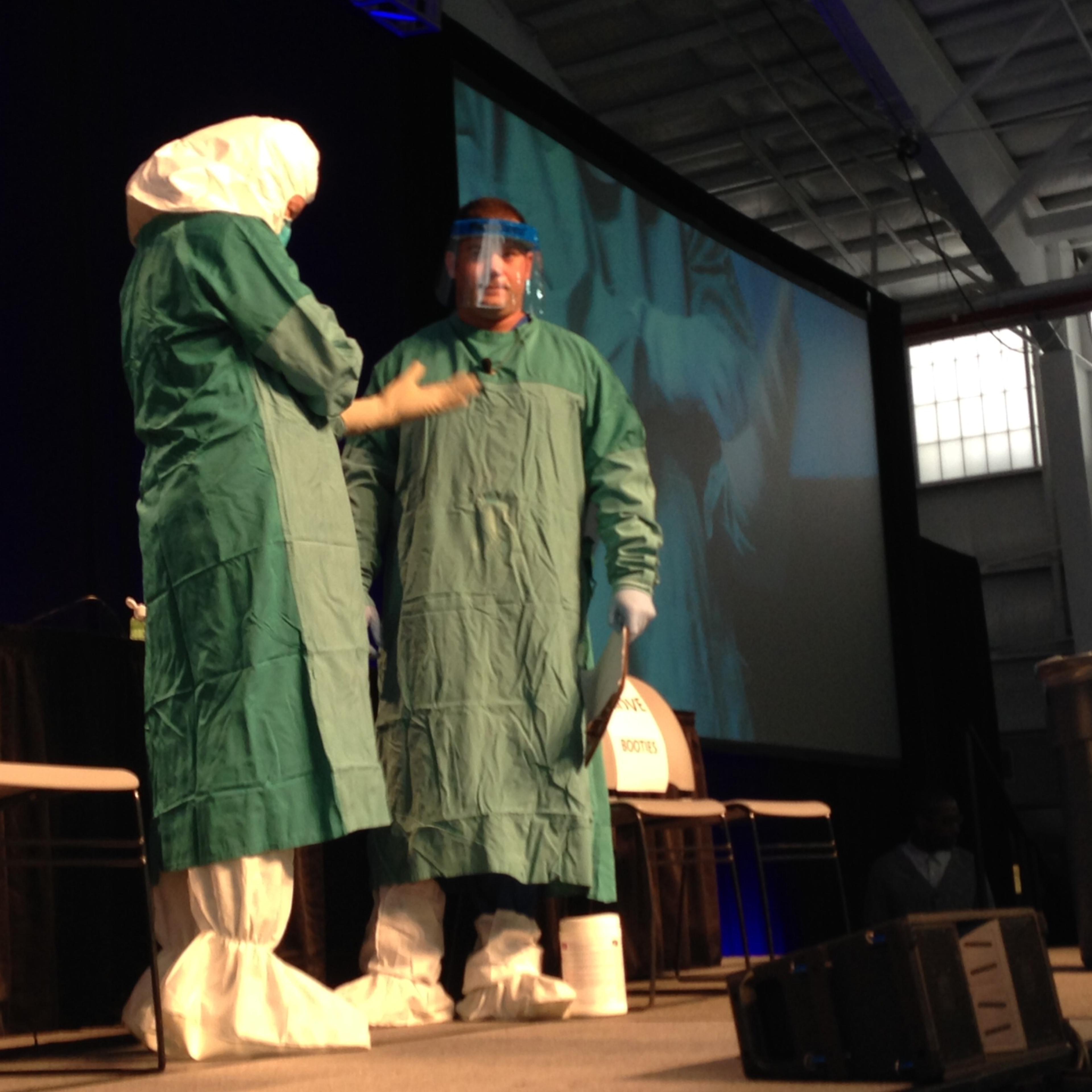 CDC and Mount Sinai health workers demonstrate how to put on and off Ebola personal protective equipment at an Ebola education session in New York City