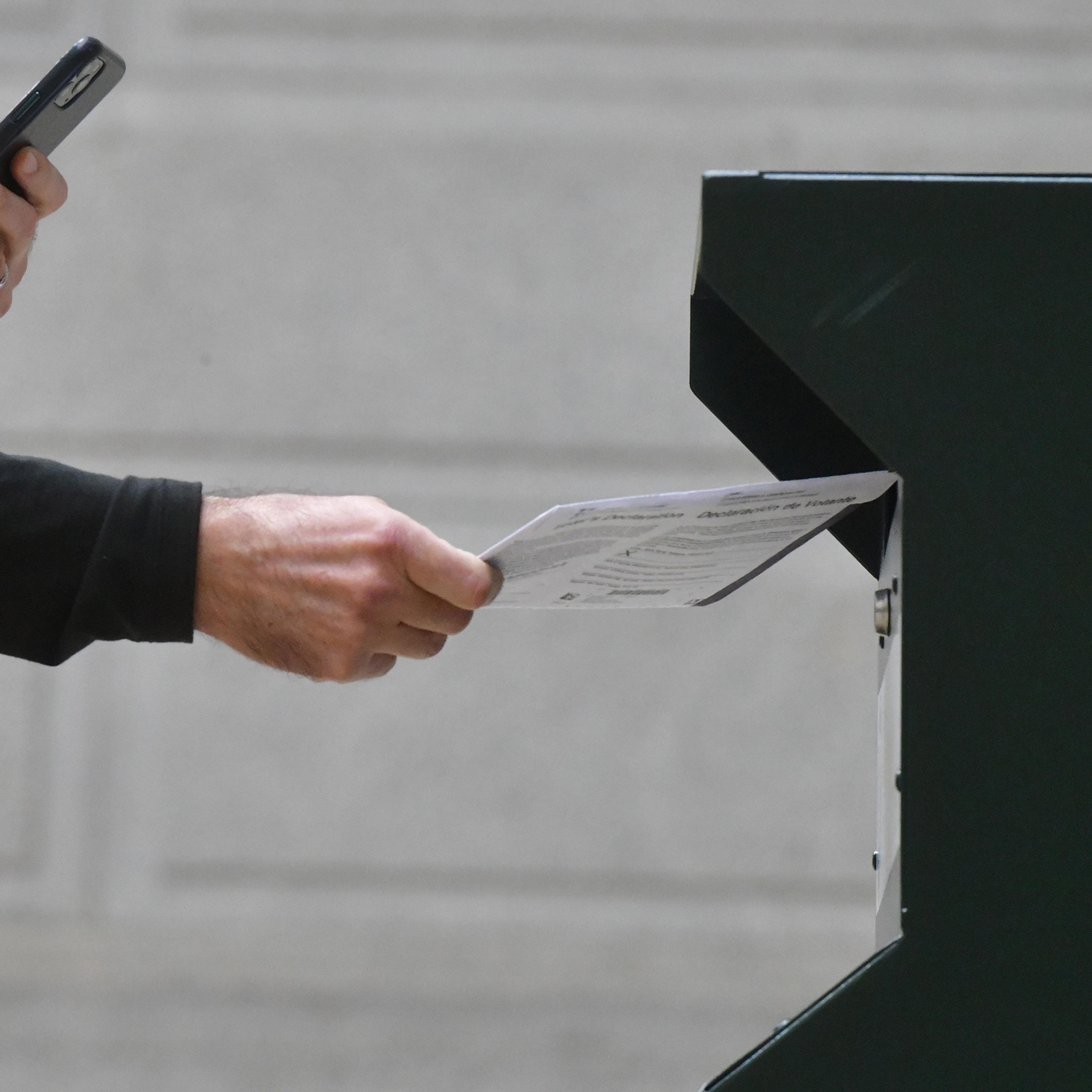 A man photographs himself depositing his ballot in an official ballot drop box outside of Philadelphia City Hall on Oct. 27. Misinformation about voting has been spreading online