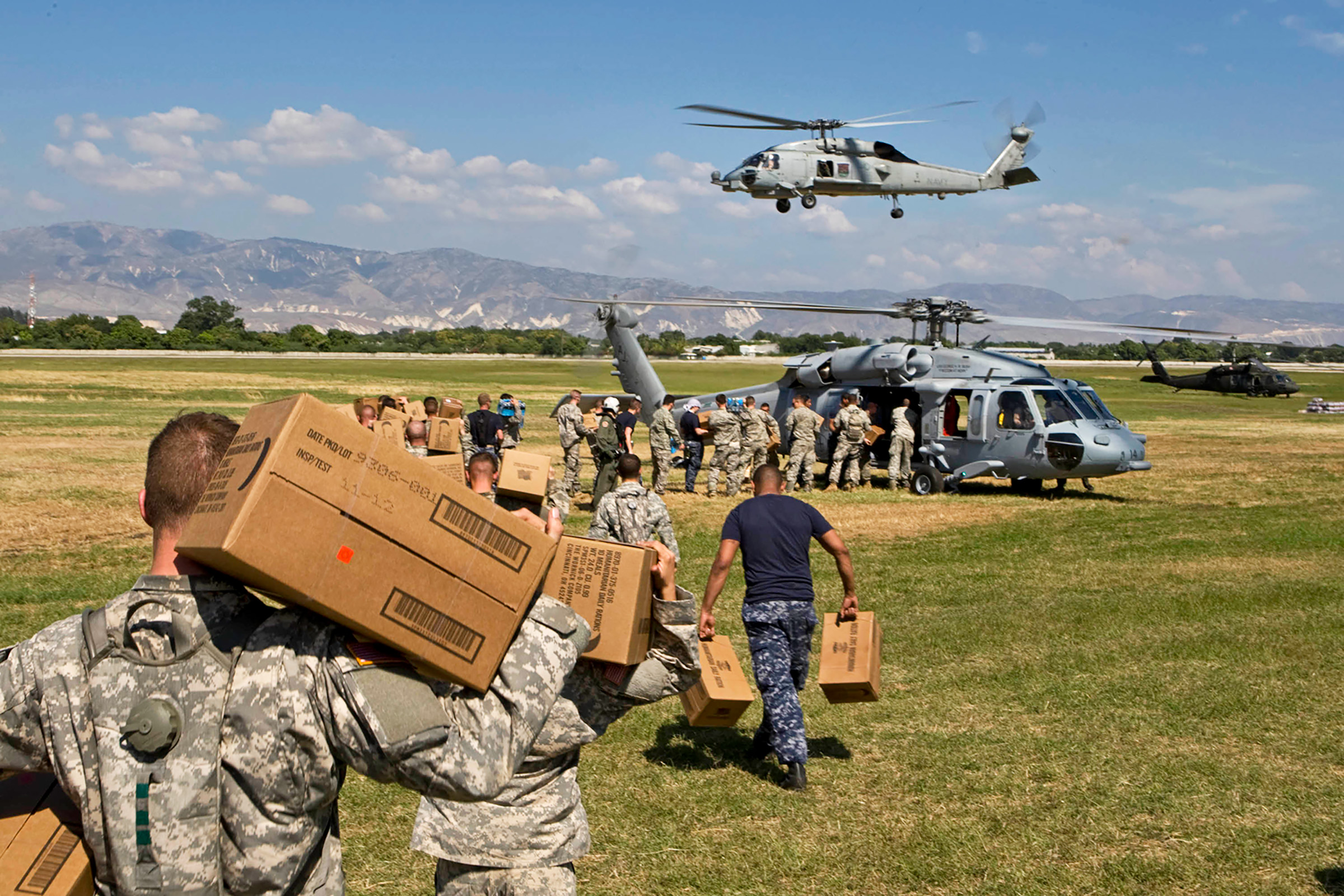 U.S. soldiers load aid onto a helicopter in January 2010 in Port-au-Prince, Haiti, after a devastating earthquake