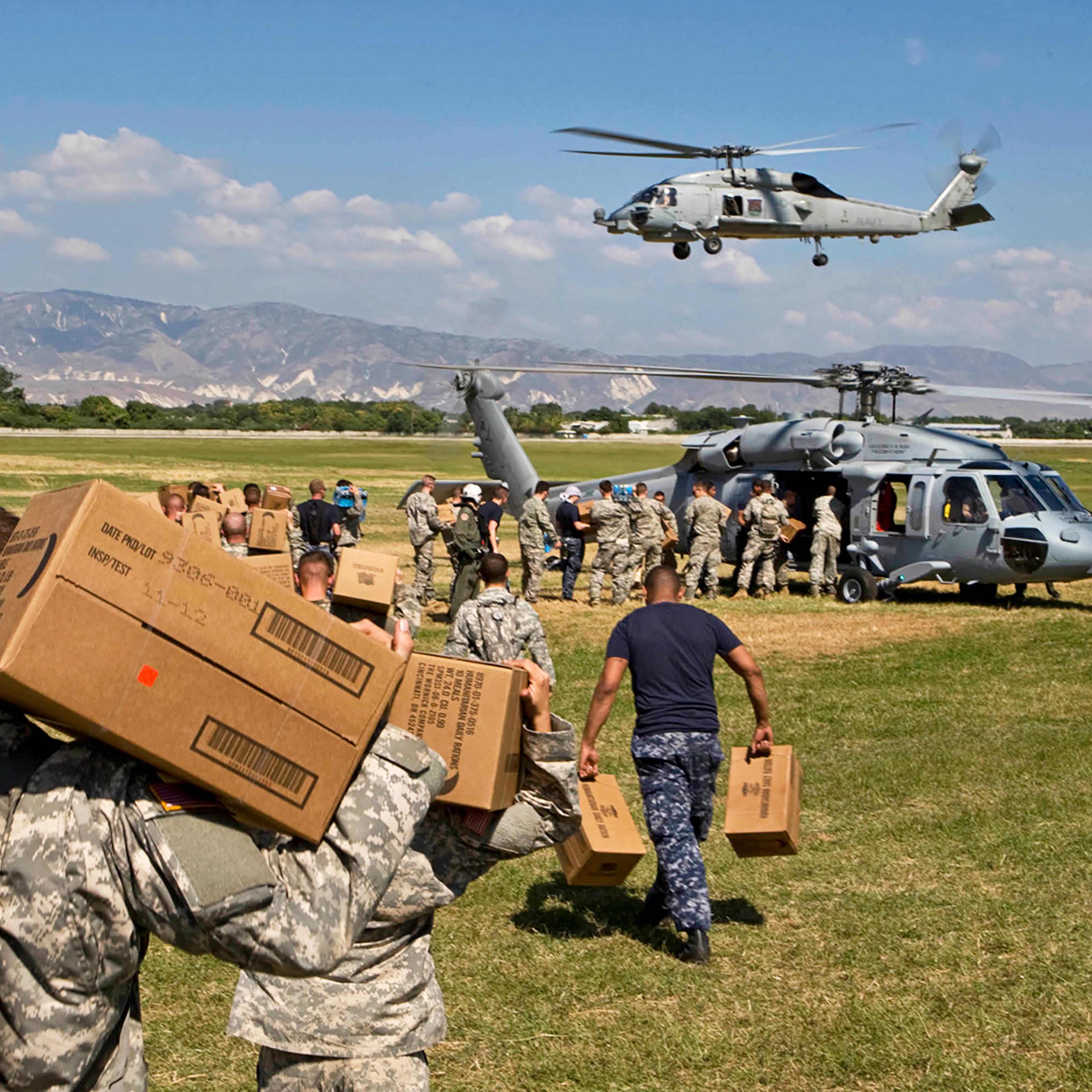 U.S. soldiers load aid onto a helicopter in January 2010 in Port-au-Prince, Haiti, after a devastating earthquake