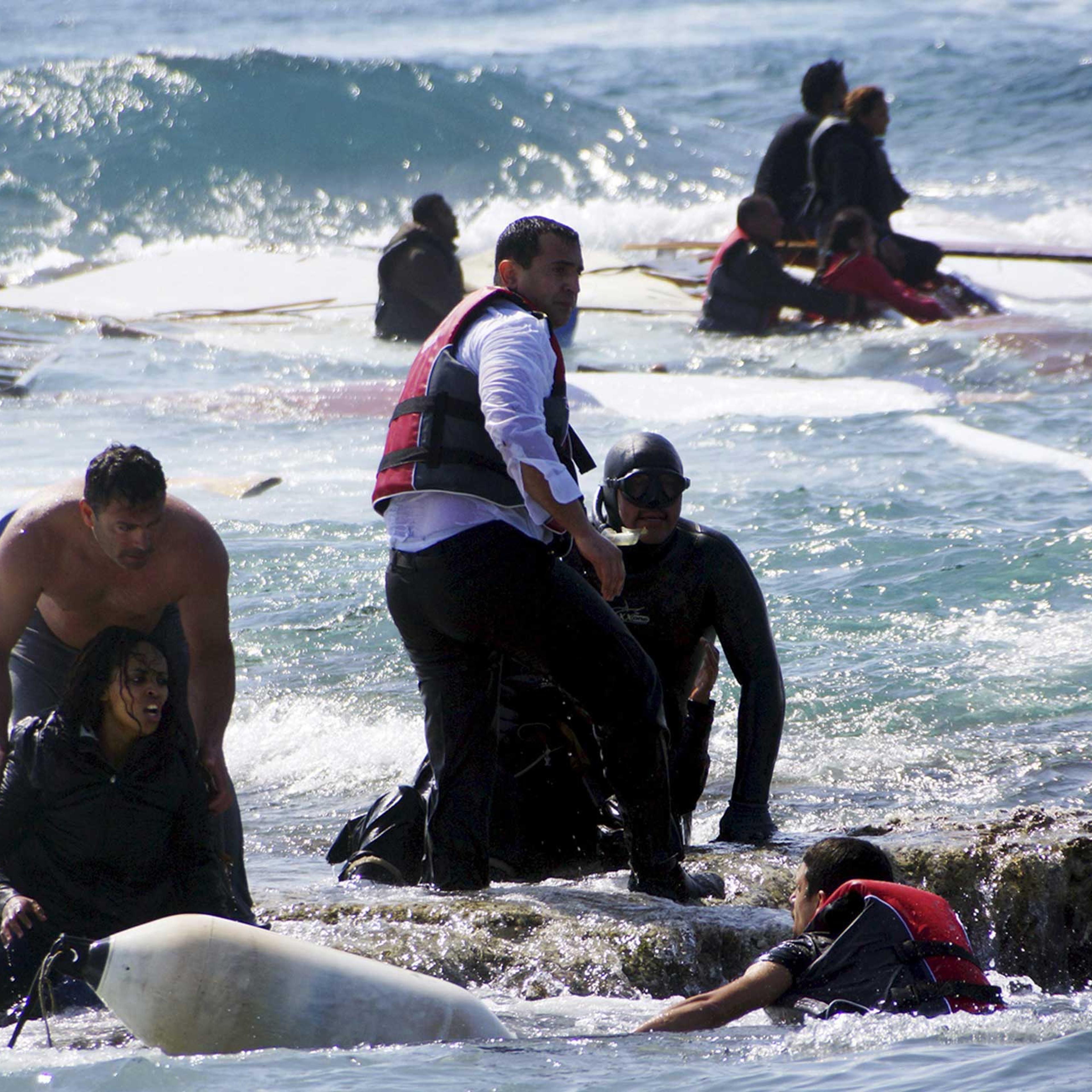 Migrants, who are trying to reach Greece, are rescued by members of the Greek Coast guard and locals near the coast of the southeastern island of Rhodes on April 20, 2015.
