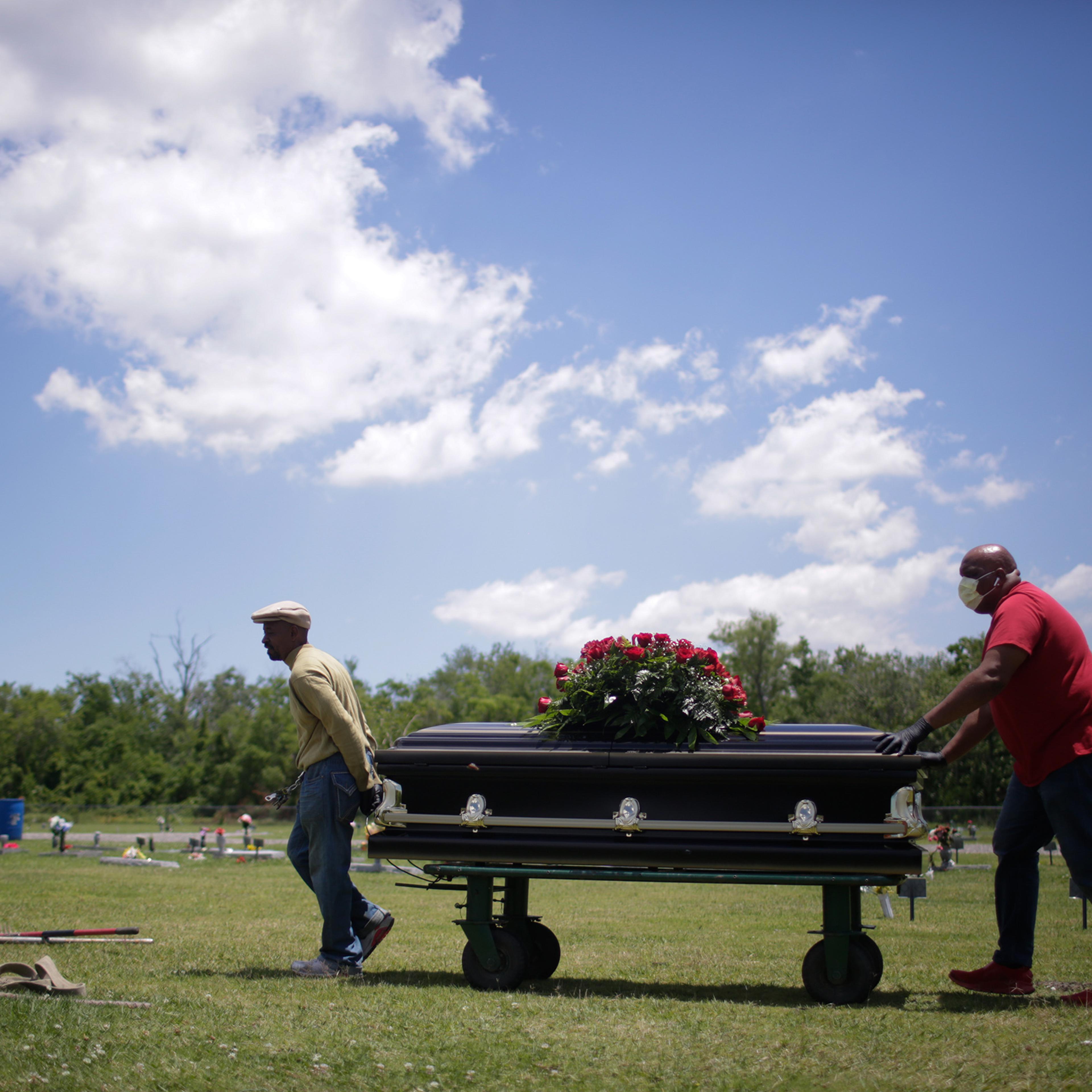 Michael Williams’ casket is carried toward his plot at Woodlawn Park Memorial Cemetery in Westwego, La., on May 18, 2020