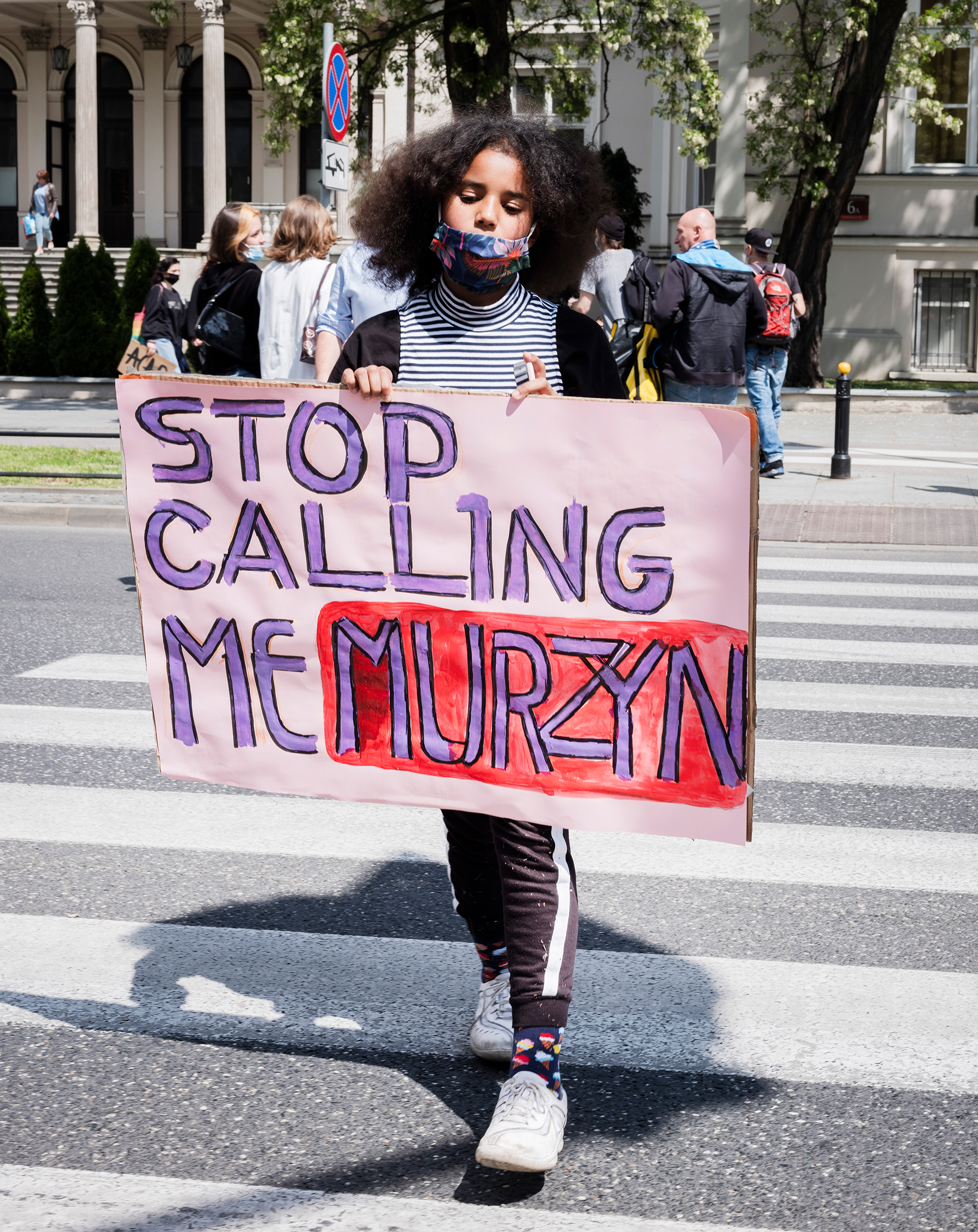 Bianka Nwolisa walks with a sign reading "Stop Calling Me Murzyn" during a protest against police brutality, in the wake of George Floyd's killing, in Warsaw on June 4, 2020.