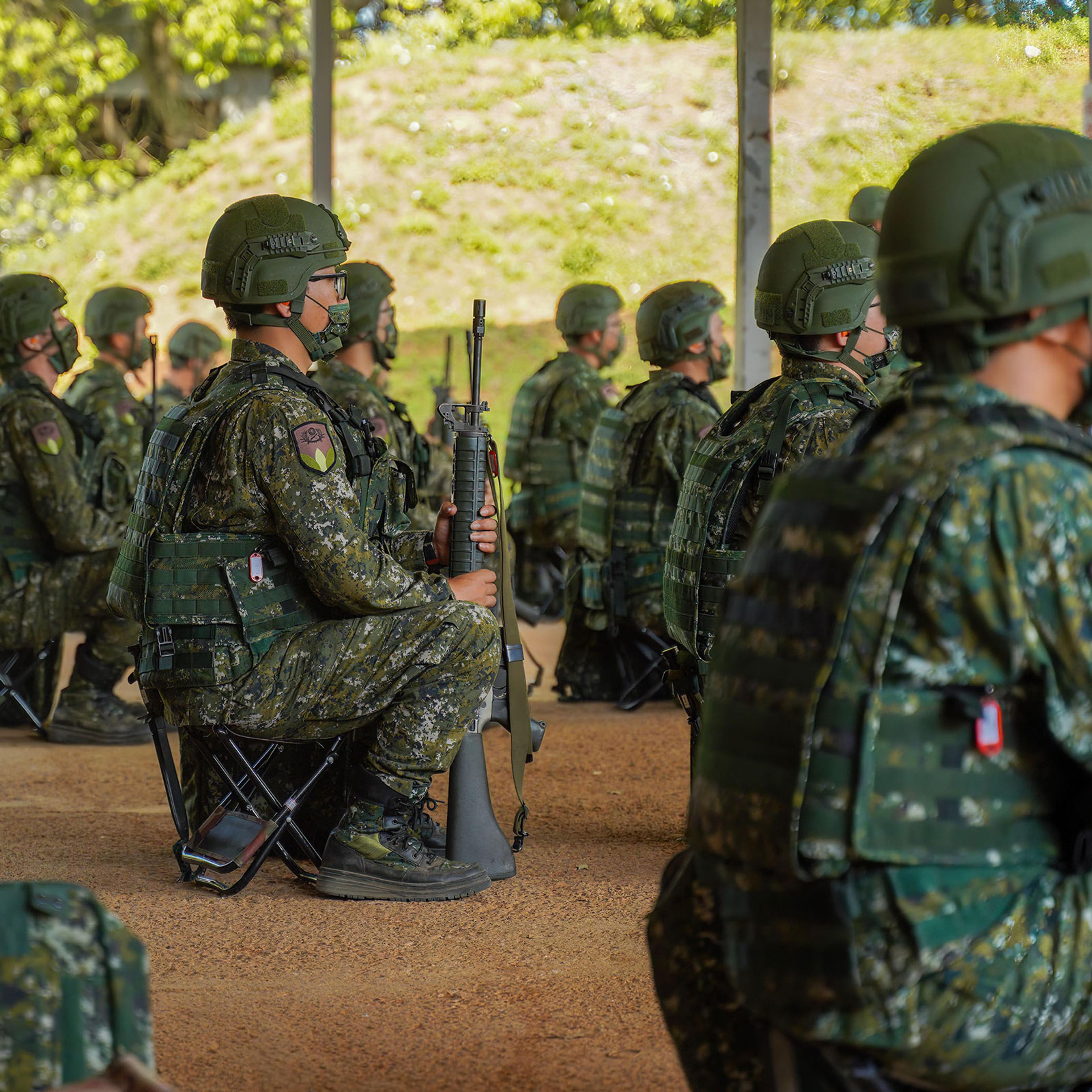 Army reservists hold riffles during training at a camp base in Taiwan on March 14, 2022.