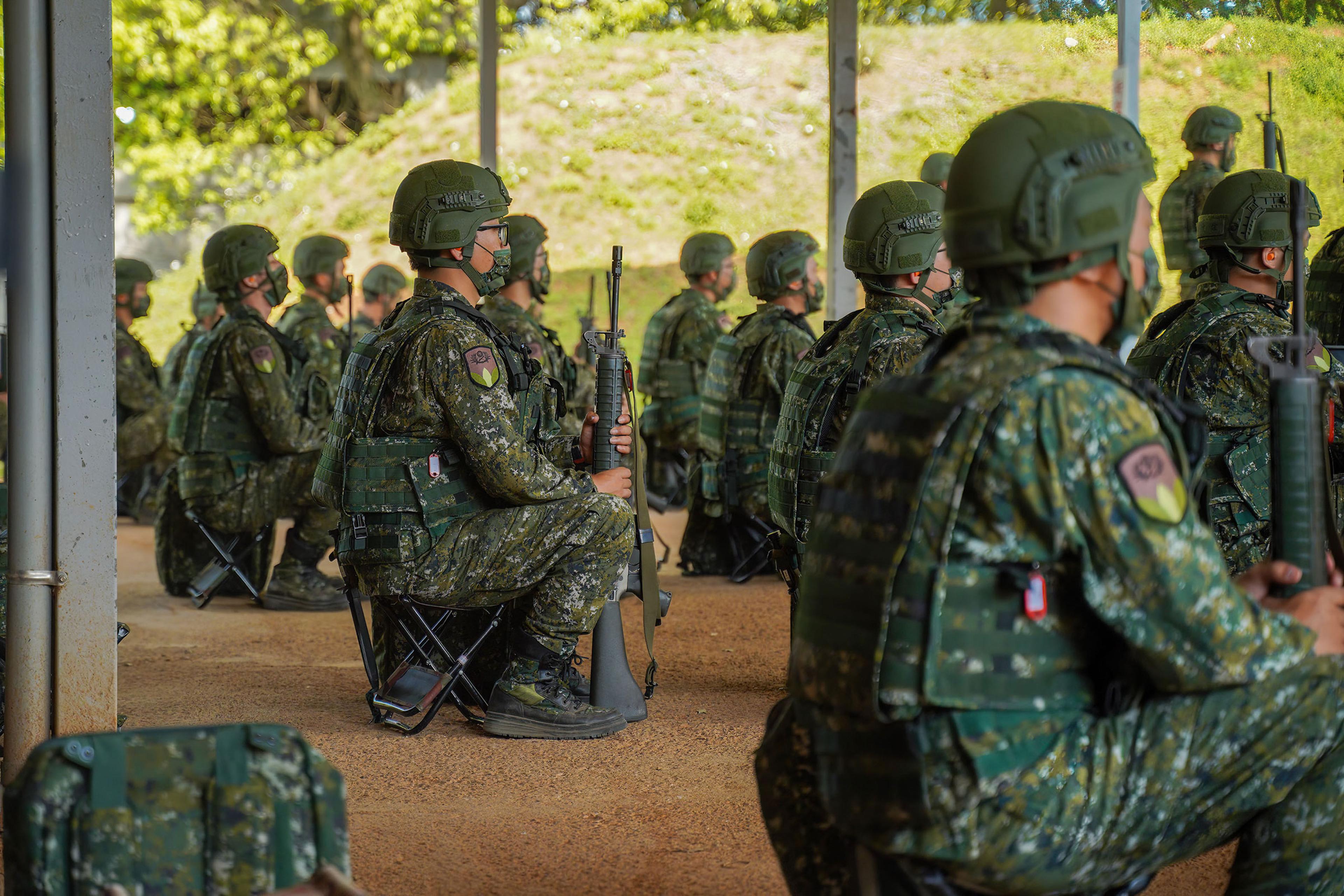 Army reservists hold riffles during training at a camp base in Taiwan on March 14, 2022.