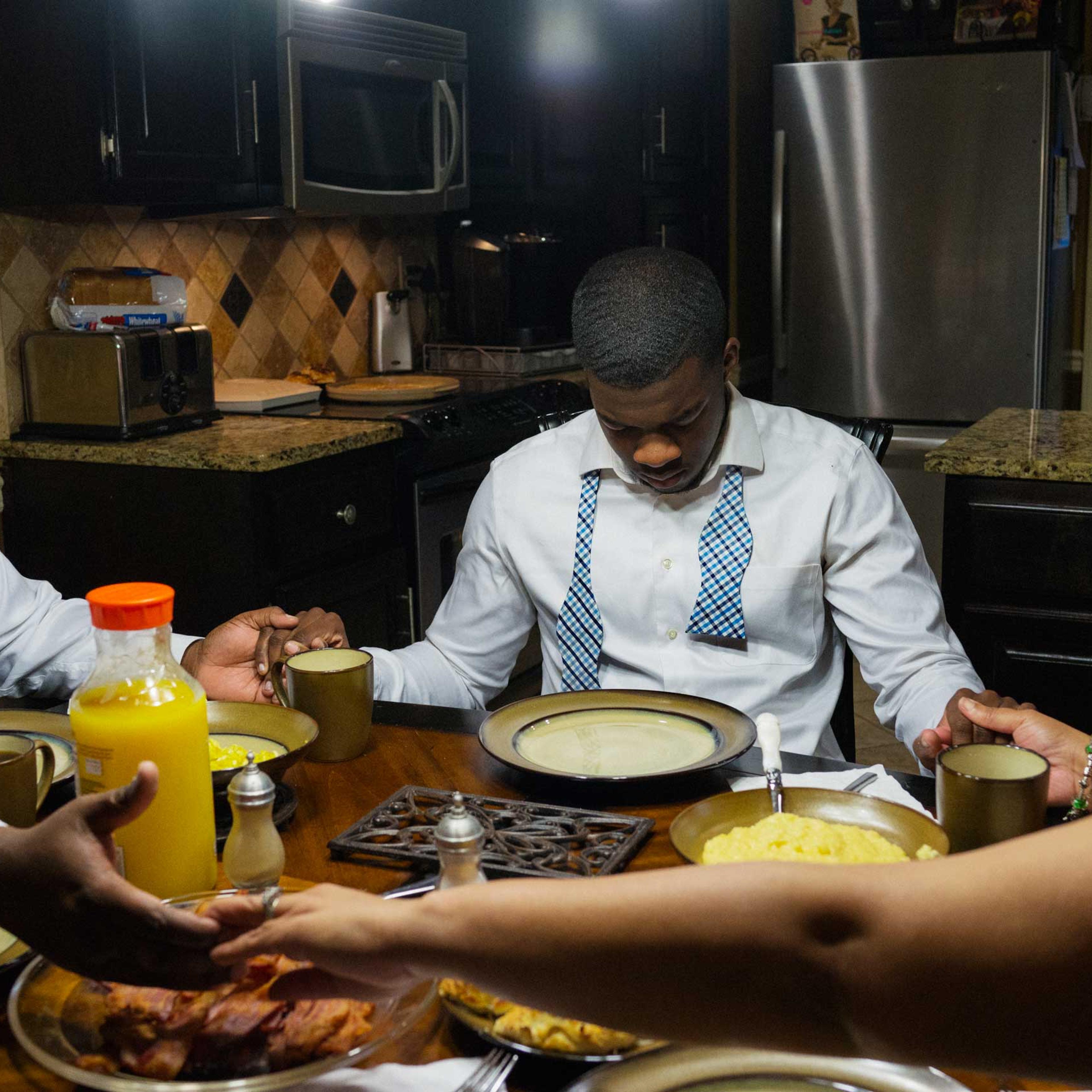 Pete Garrett prays over breakfast, with his son P.J. and wife Dr. Cynthia Garrett, at their home in Trussvile, Ala. before attending Sunday worship at the Sixteenth Street Baptist Church on March 22, 2015.