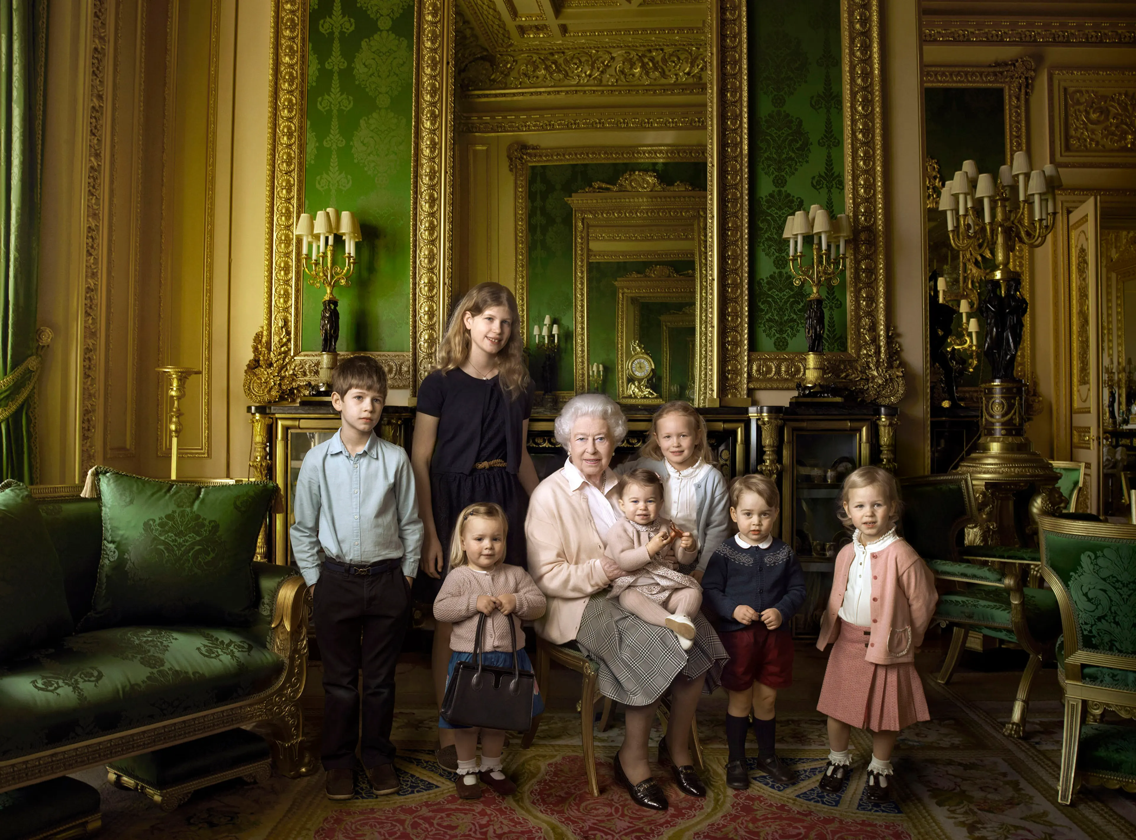 Queen Elizabeth II with her five great-grandchildren and her two youngest grandchildren in the Green Drawing Room, part of Windsor Castle's semi-State apartments in Windsor England. The children are: James, Viscount Severn, 8-years-old, left, and Lady Lo