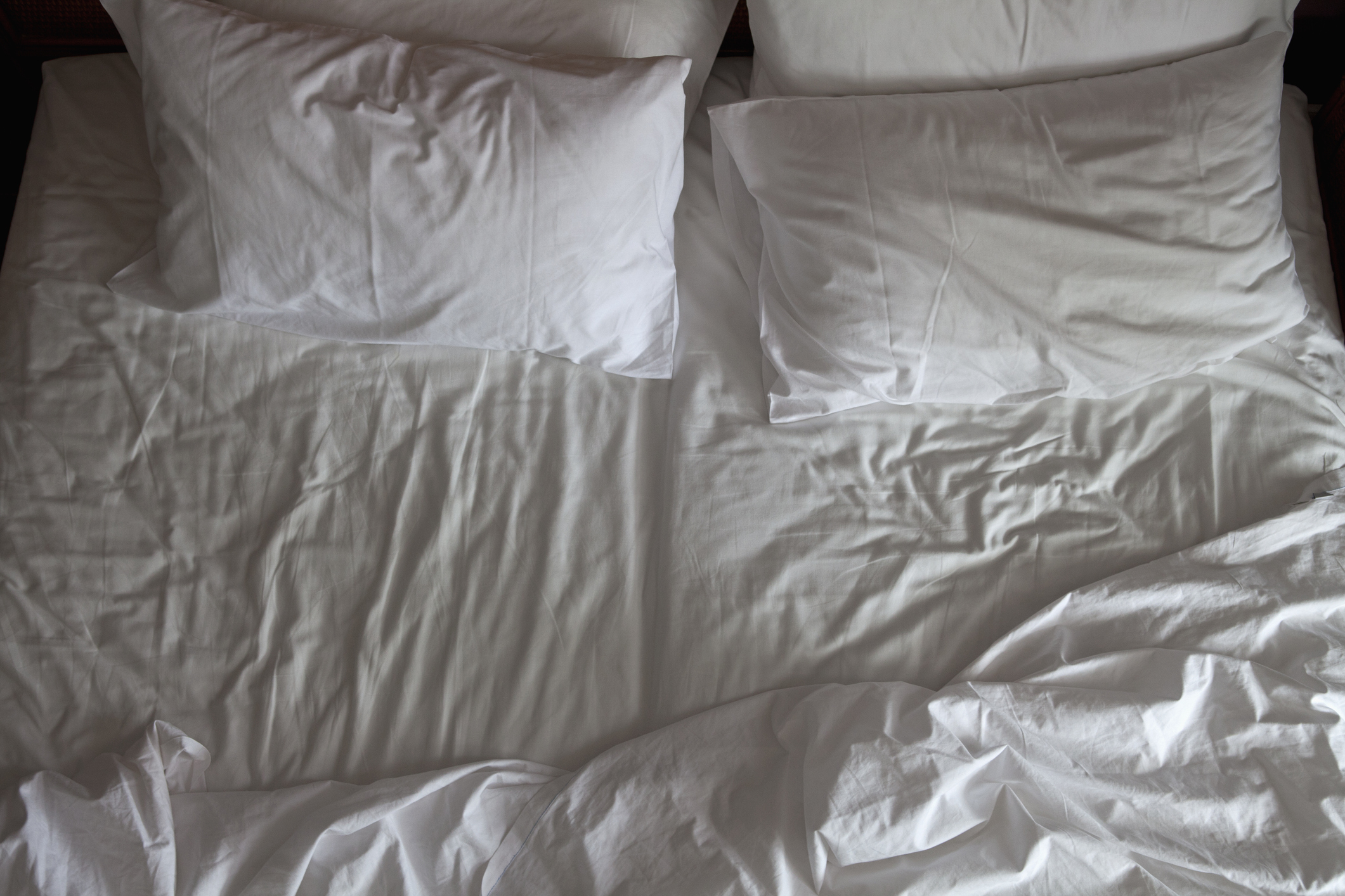 Detail of an unmade double bed
