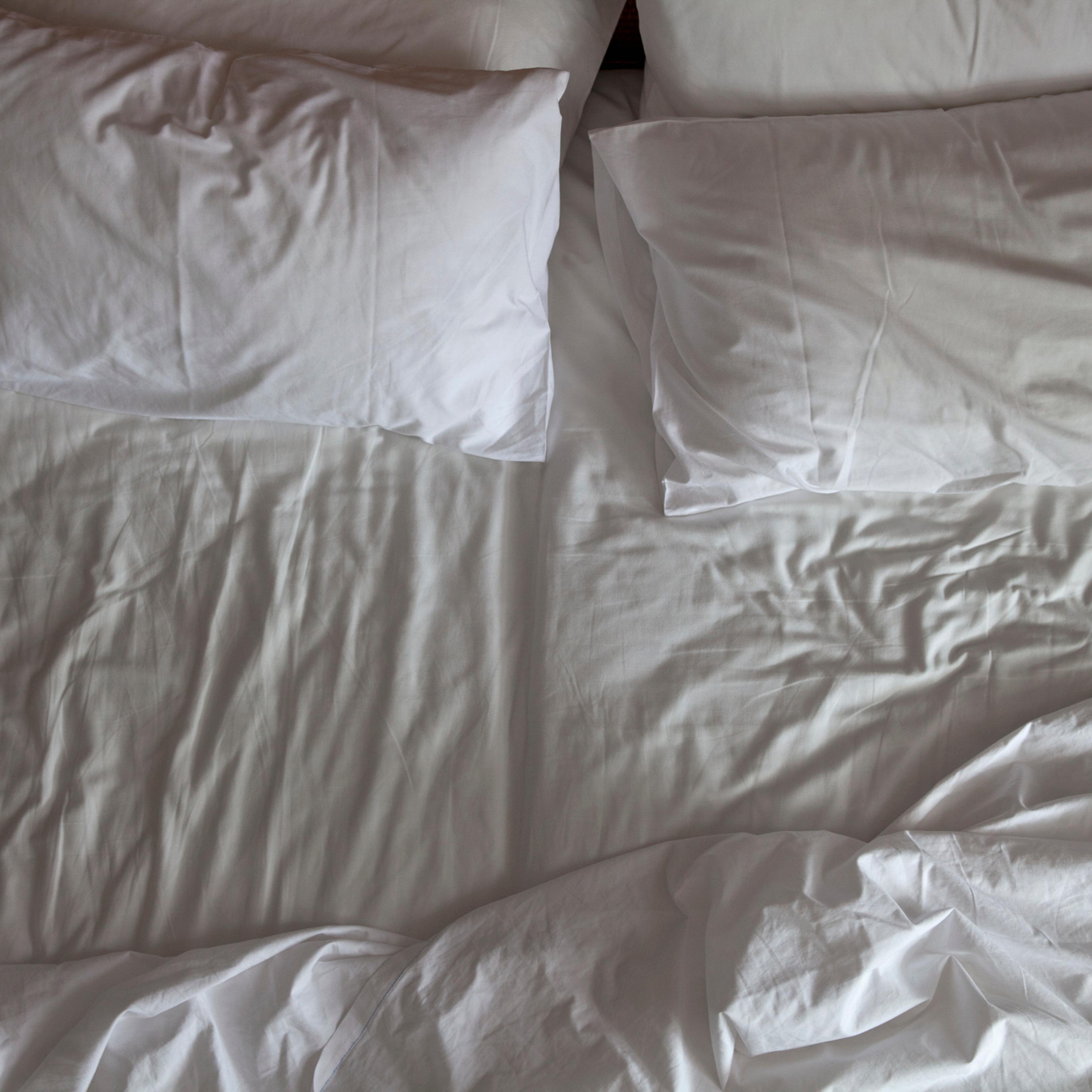 Detail of an unmade double bed
