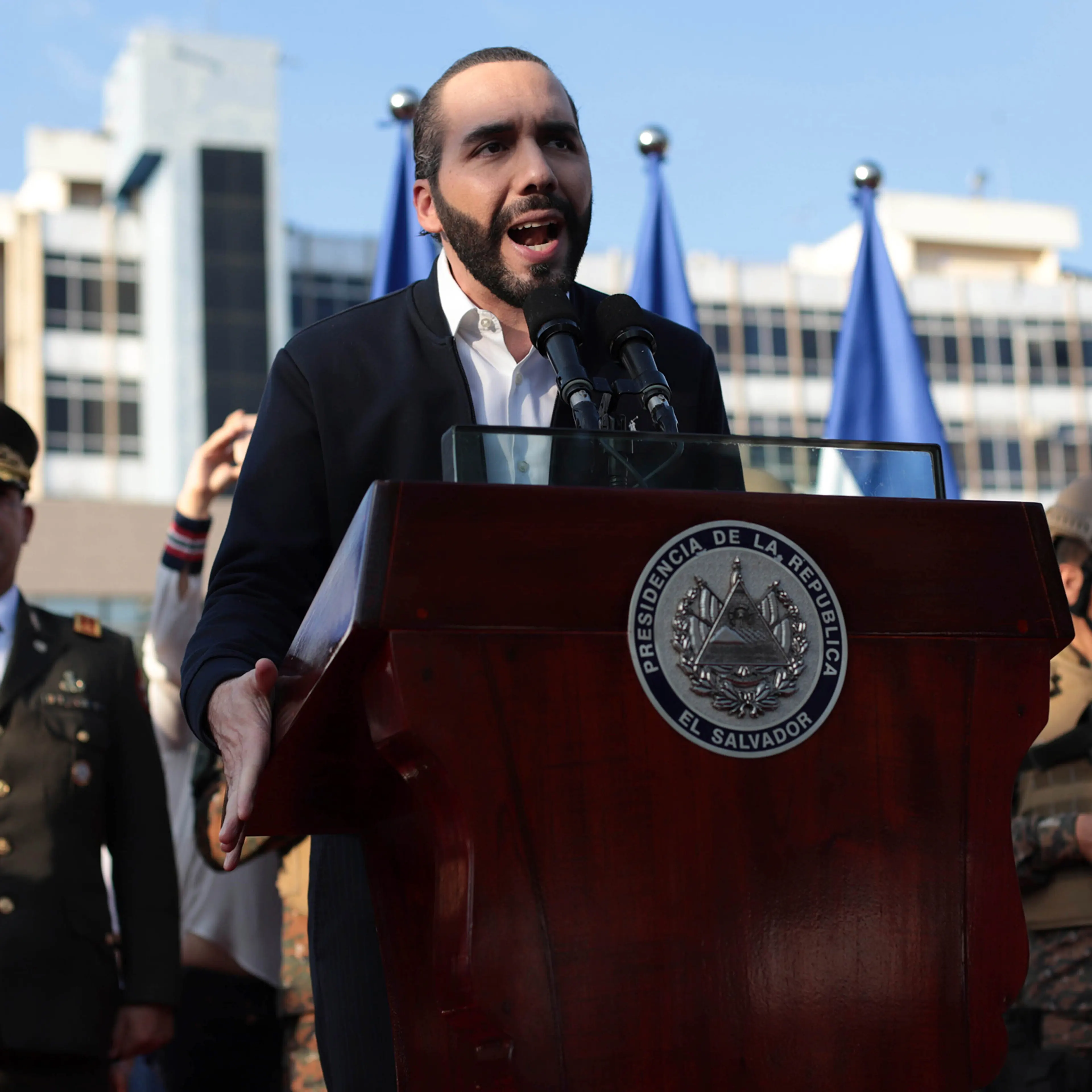 El Salvador's President Nayib Bukele, accompanied by members of the armed forces, speaks to his supporters outside Congress in San Salvador on Feb. 9. Bukele's party has swept all three main opposition parties during 2021's midterm elections, giving him