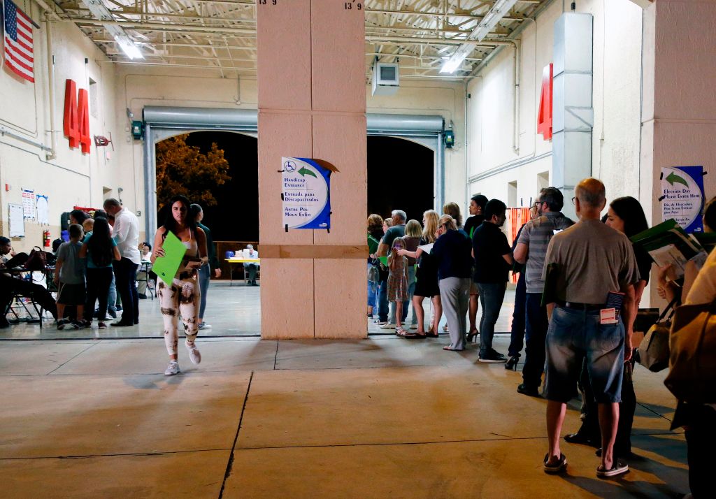 People wait in line to vote at a polling station in Miami, Florida
