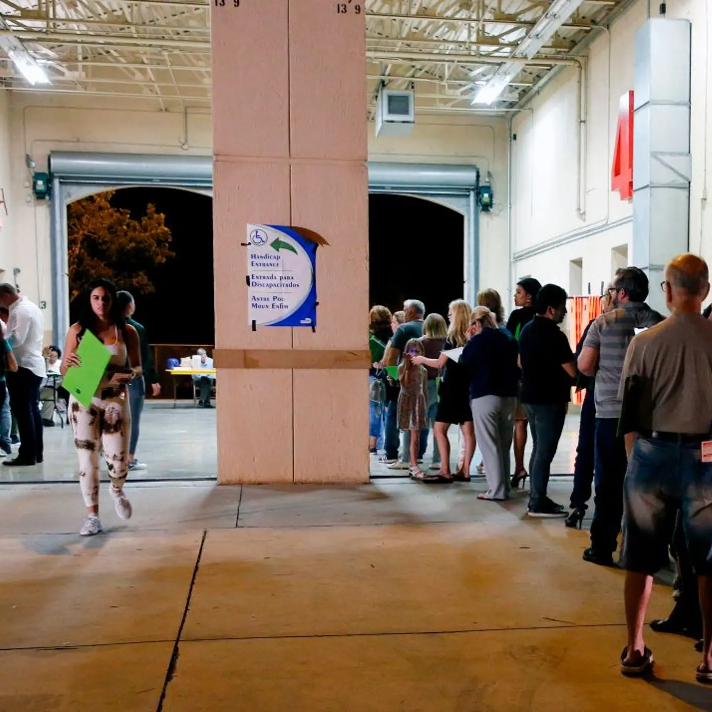 People wait in line to vote at a polling station in Miami, Florida