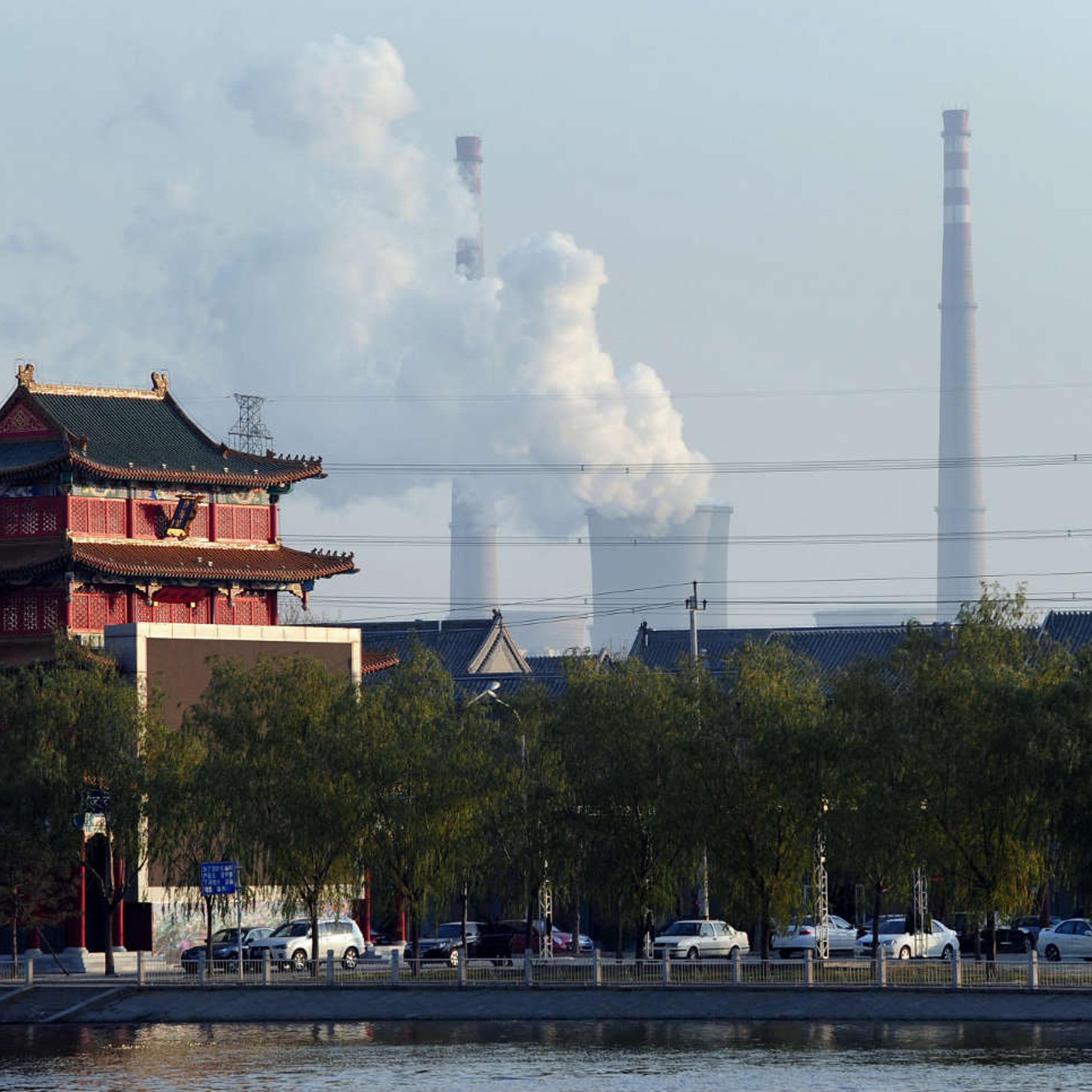 A coal plant looms behind a traditional house in Tianjin, China