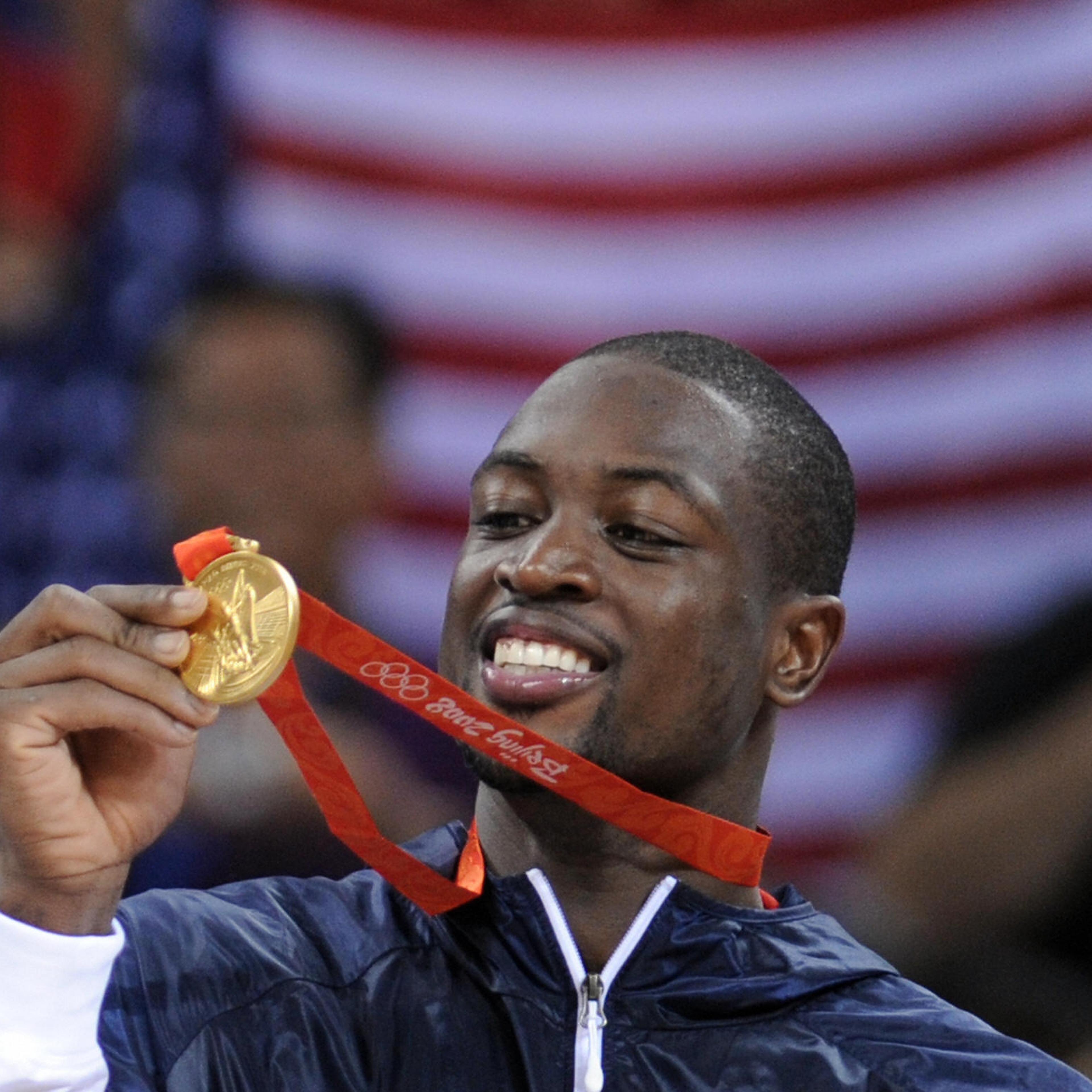 USA's Dwyane Wade shows his medals on th