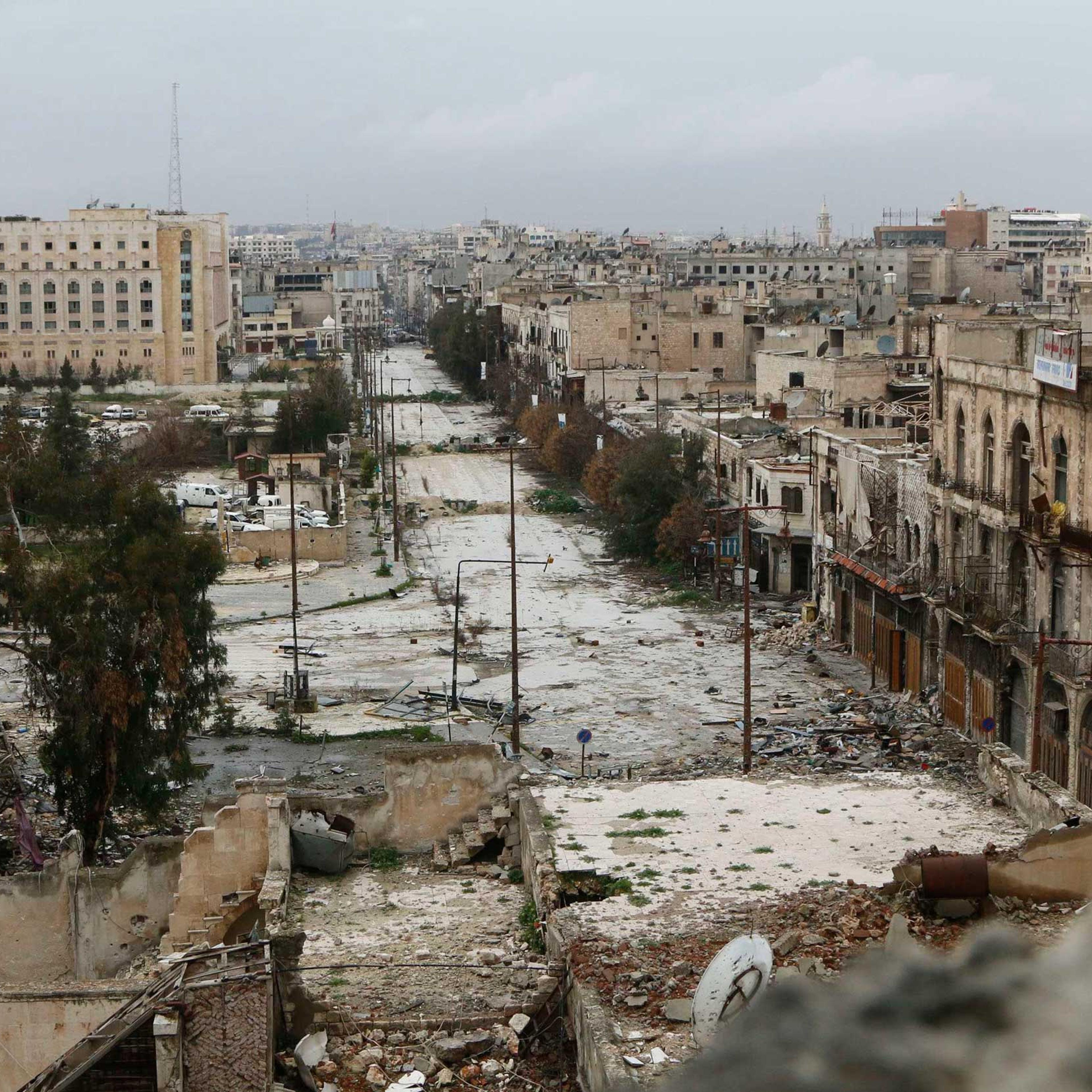 A general view shows damaged buildings along a deserted street and an area controlled by forces loyal to Syria's President Bashar Assad, as seen from a rebel-controlled area at the Bab al-Nasr frontline in Aleppo, Feb. 10, 2015.