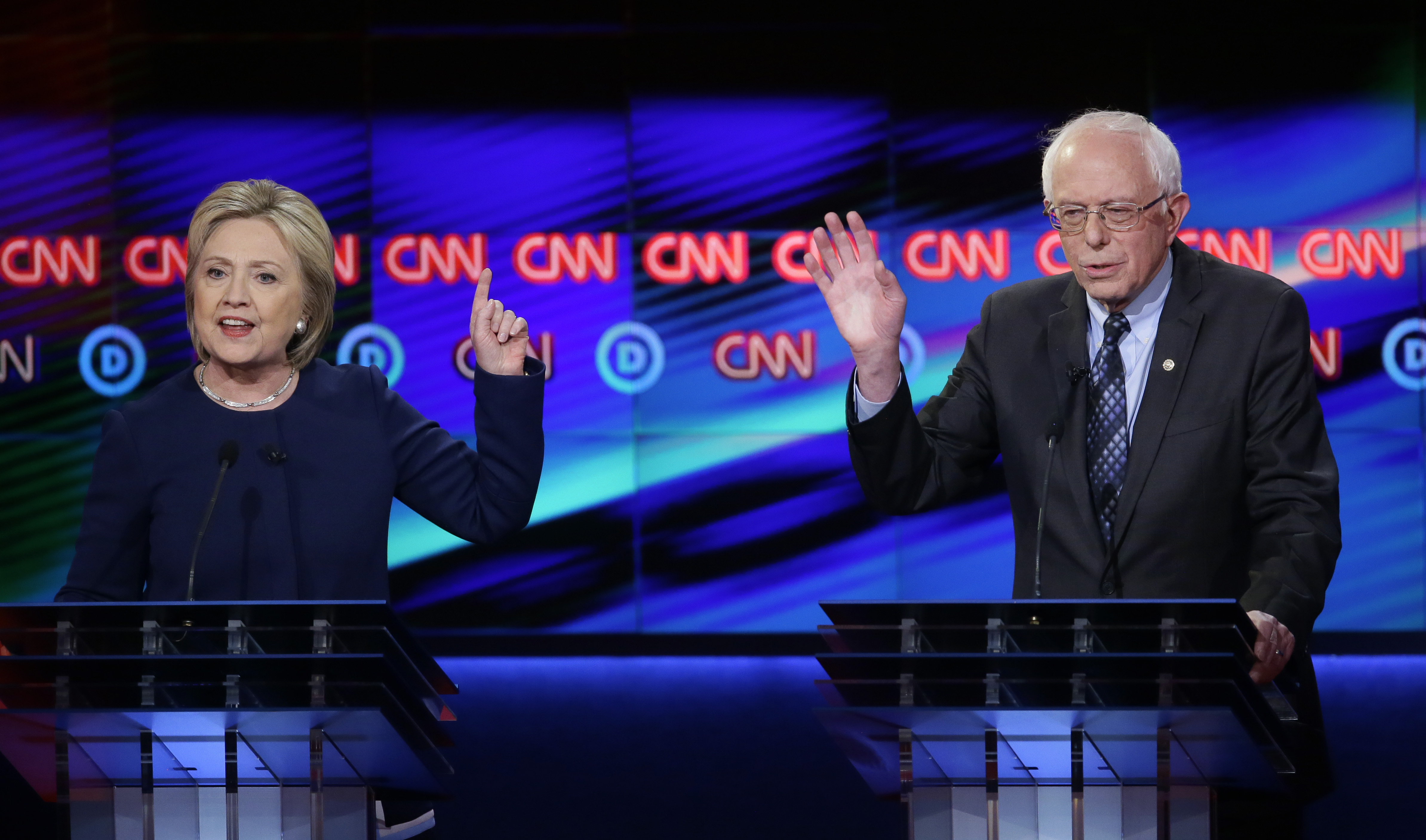 Hillary Clinton argues a point as Bernie Sanders reacts during a Democratic presidential primary debate at the University of Michigan-Flint in Flint, Mich. on March 6, 2016.