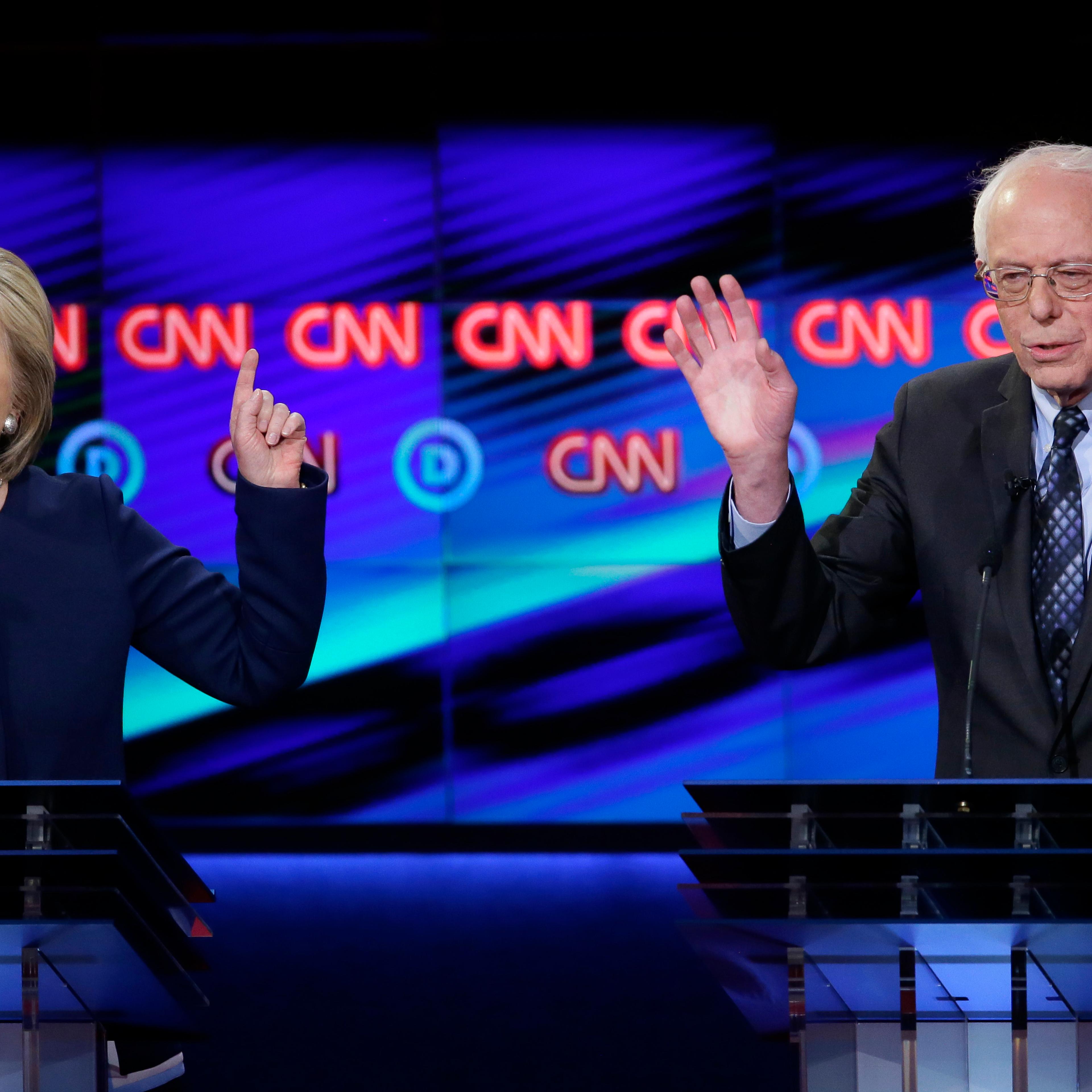 Hillary Clinton argues a point as Bernie Sanders reacts during a Democratic presidential primary debate at the University of Michigan-Flint in Flint, Mich. on March 6, 2016.
